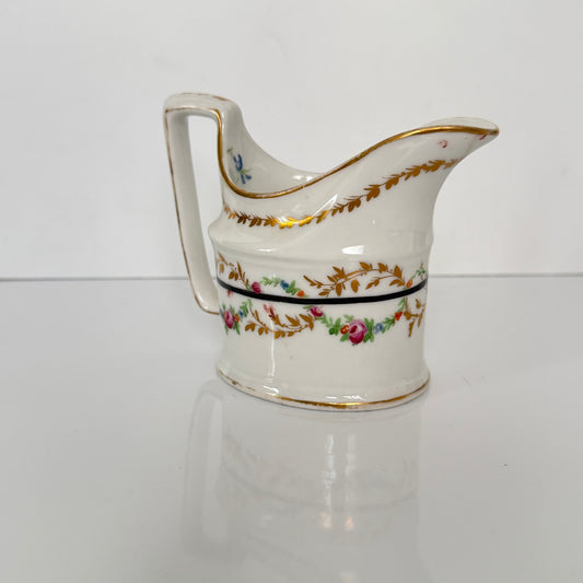 Antique Clignancourt hard-paste porcelain milk jug, hand-painted floral garlands, 18th century France.