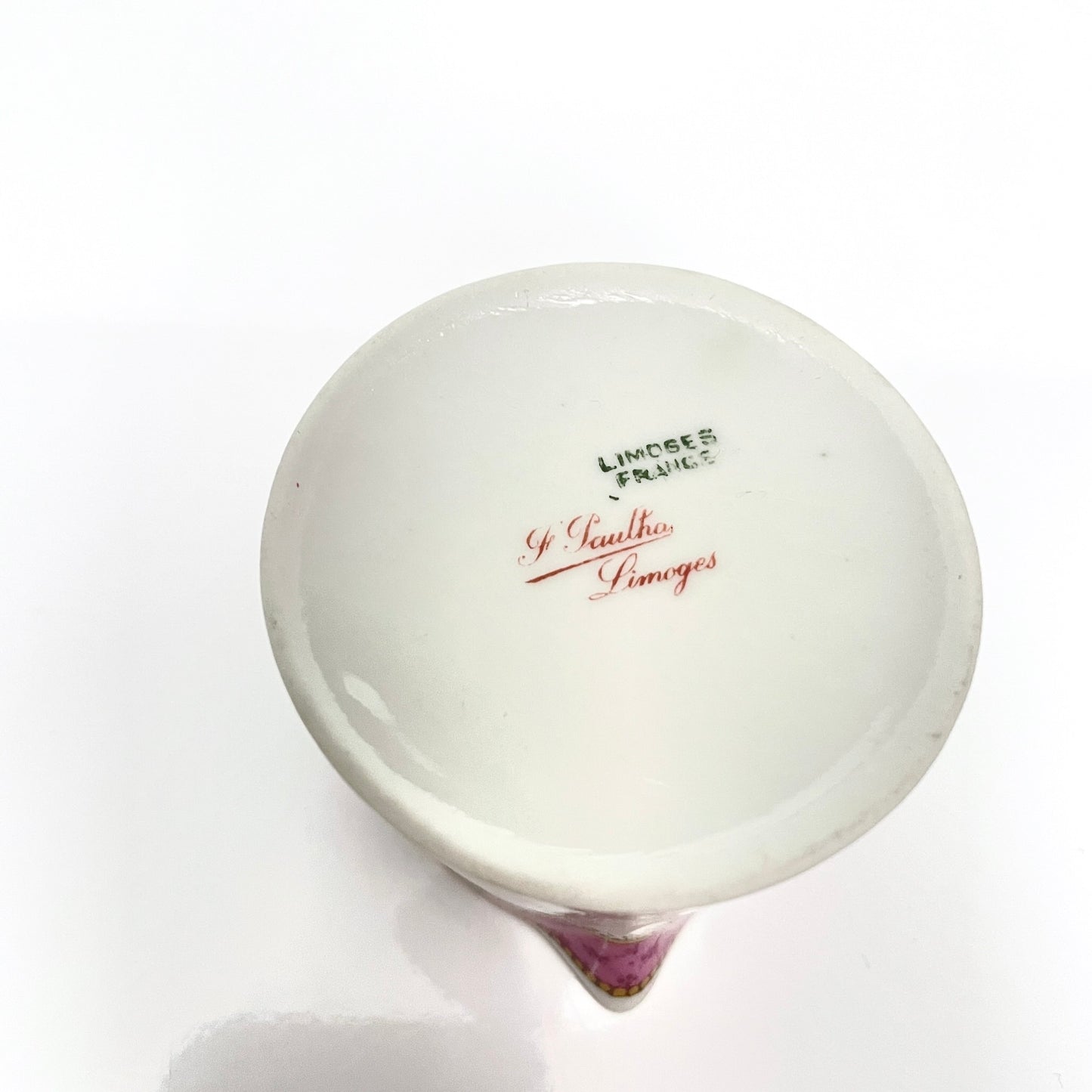 This is a Limoges porcelain milk jug with a delicate floral rose design, made by F. Paulhat. It showcases fine craftsmanship typical of Limoges porcelain.