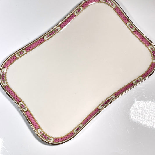 This is a Limoges porcelain tray with a delicate floral rose design and a soft pink border, perfect for tea or coffee service. It is signed by F. Paulhat Limoges, France.