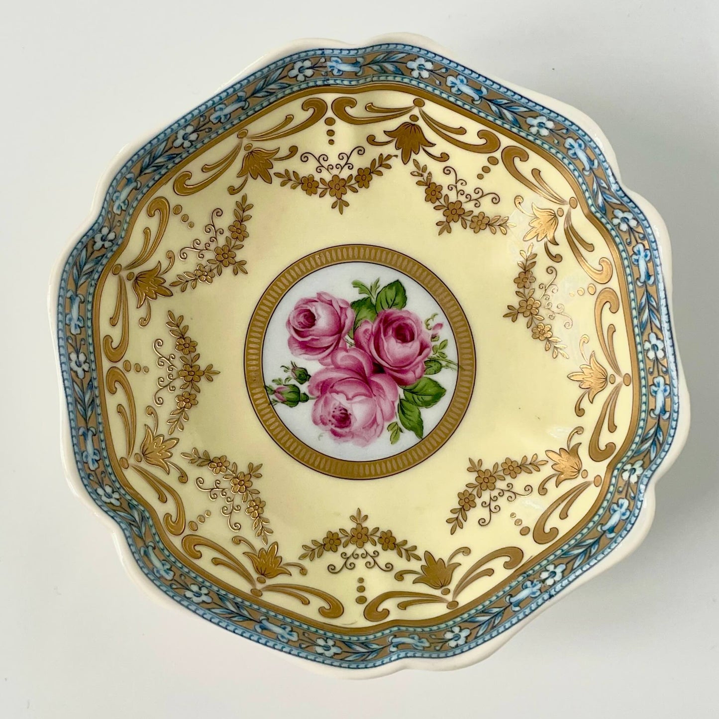 Porcelain trinket tray inspired by 18th-century Sèvres, featuring delicate roses and a golden garland, adding elegance to any room.