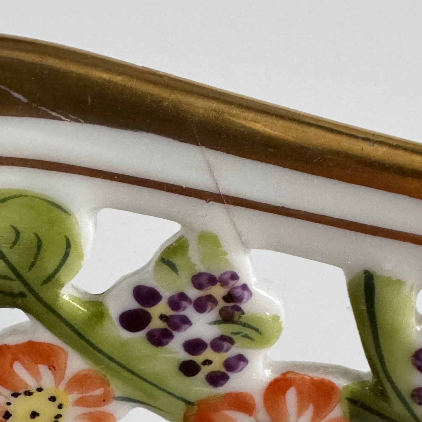 Français: Coupe à fruits en porcelaine RW Bavaria, début XXe siècle, décor floral peint à la main et percé, dorure avec motifs de fruits, signée RW Bavaria ; English: RW Bavaria porcelain fruit bowl, early 20th century, hand-painted floral decoration with pierced design, gilding featuring fruit motifs, signed RW Bavaria ; 日本語: RWババリア(バイエルン)の磁器製フルーツボウル、20世紀初期、手描きの花柄と透かし模様、フルーツモチーフの金彩、RW Bavariaのサイン入り