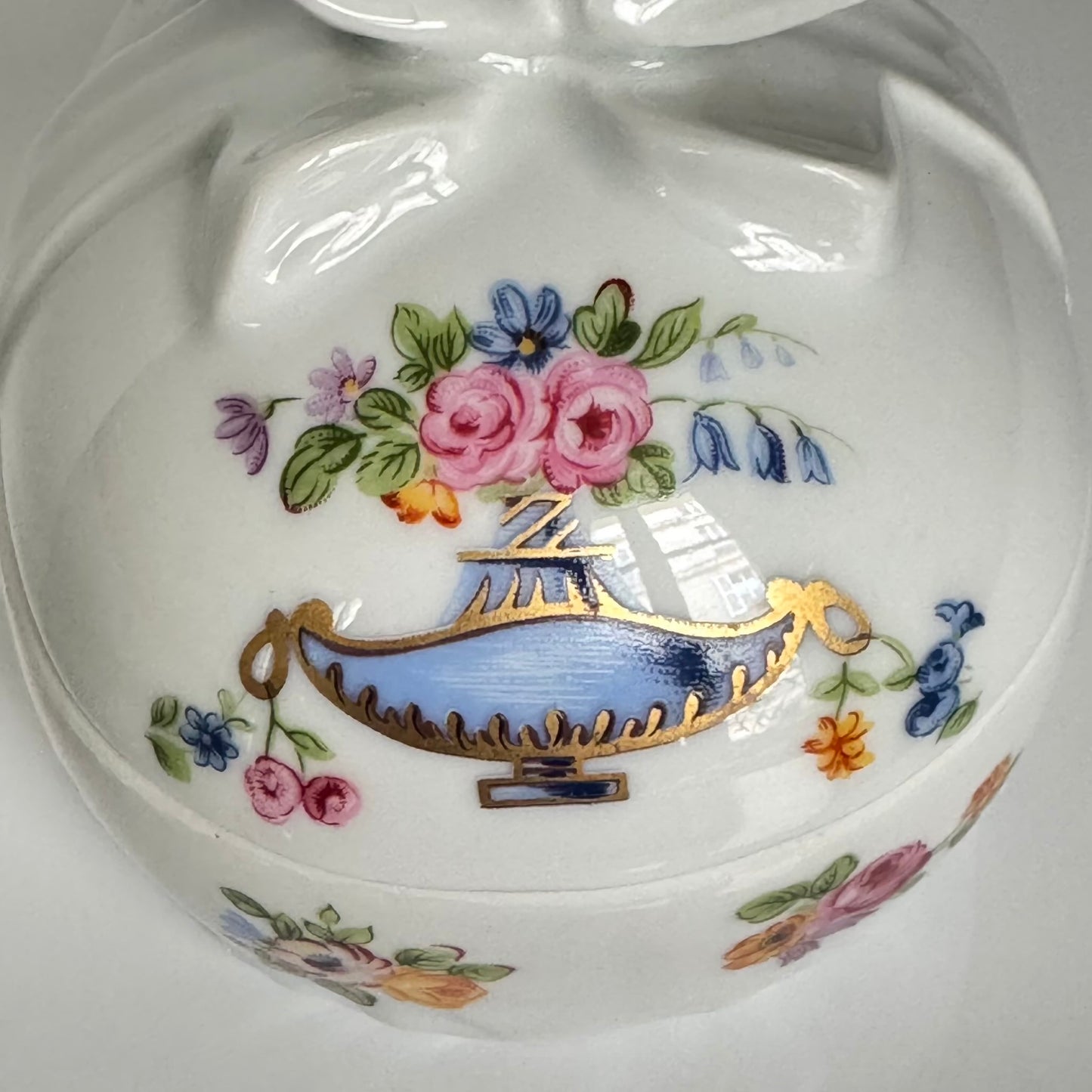 Vintage porcelain egg-shaped box by APILCO, inspired by the 18th-century Sèvres du Barry service. Features ribbon details, floral patterns, and “DB” initials in elegant design