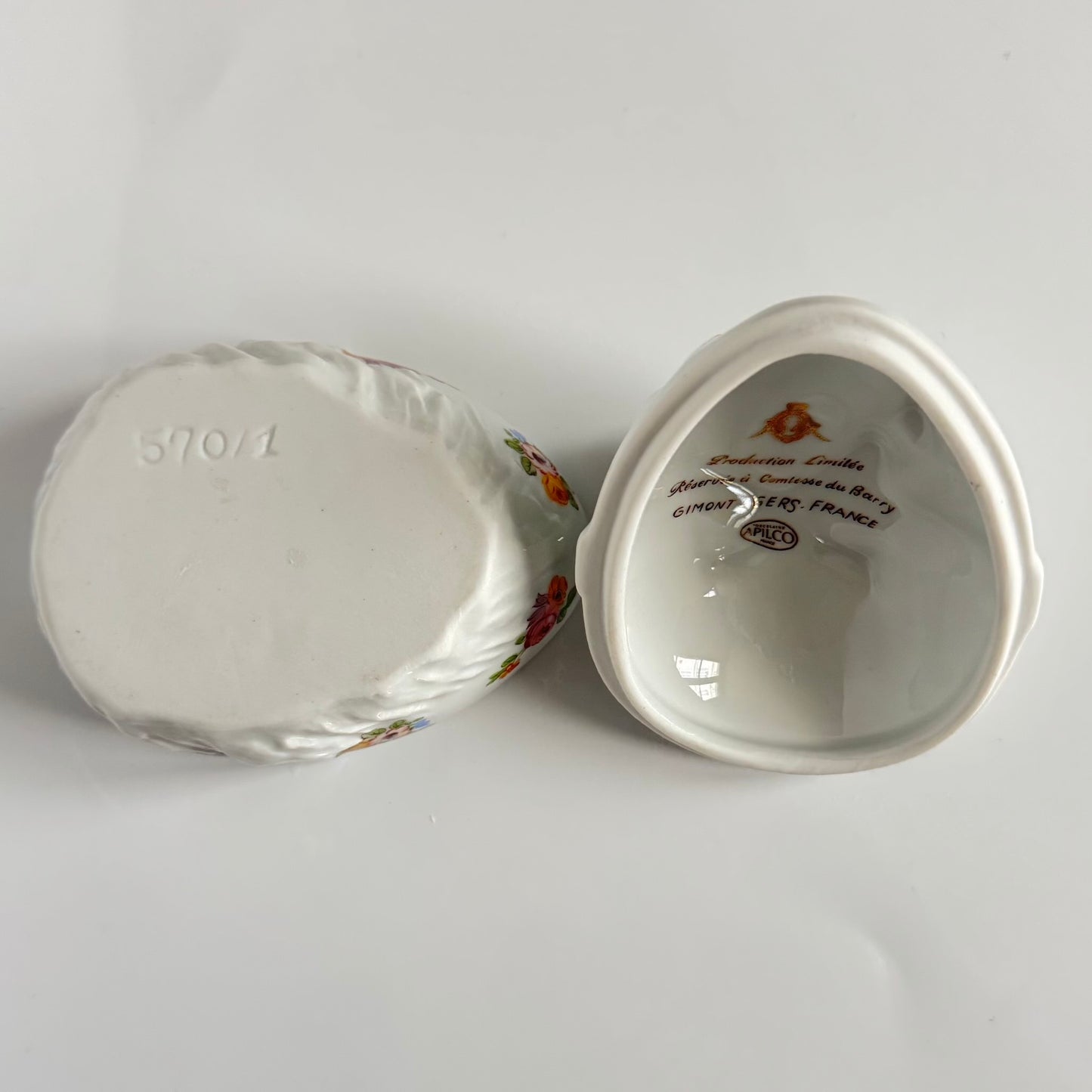 Vintage porcelain egg-shaped box by APILCO, inspired by the 18th-century Sèvres du Barry service. Features ribbon details, floral patterns, and “DB” initials in elegant design
