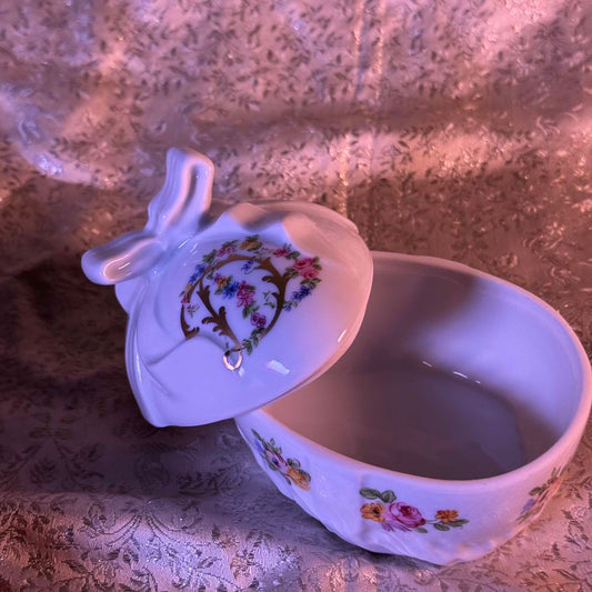 Vintage porcelain egg-shaped box by APILCO, inspired by the 18th-century Sèvres du Barry service. Features ribbon details, floral patterns, and “DB” initials in elegant design