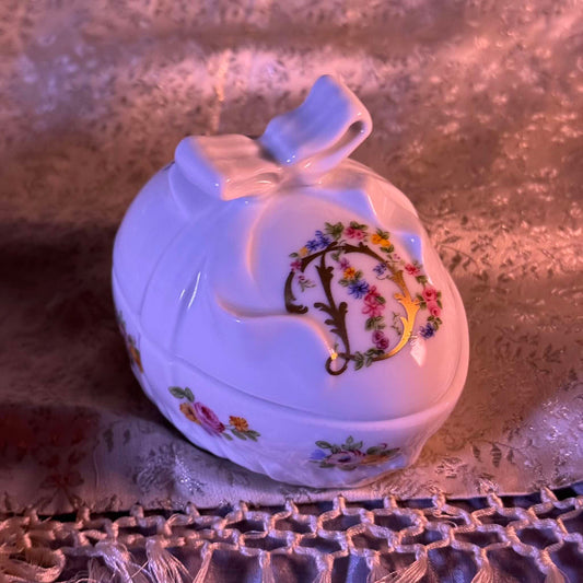 Vintage porcelain egg-shaped box by APILCO, inspired by the 18th-century Sèvres du Barry service. Features ribbon details, floral patterns, and “DB” initials in elegant design