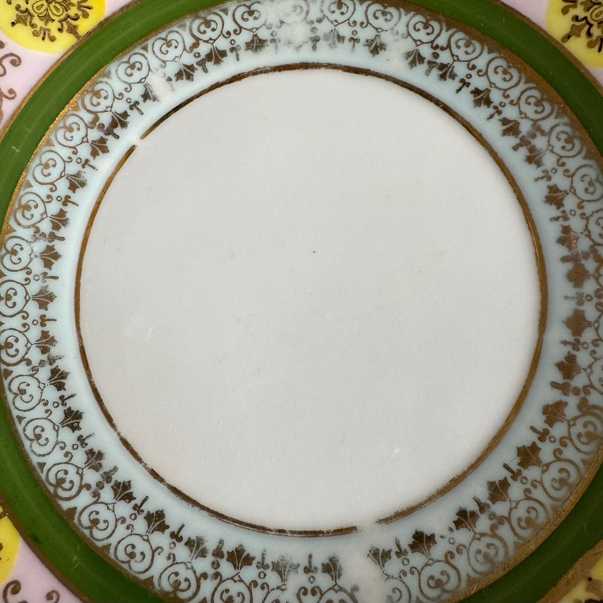 Porcelain cup and saucer set inspired by 18th-century Sèvres style, with delicate pink and green hues and gilded details.