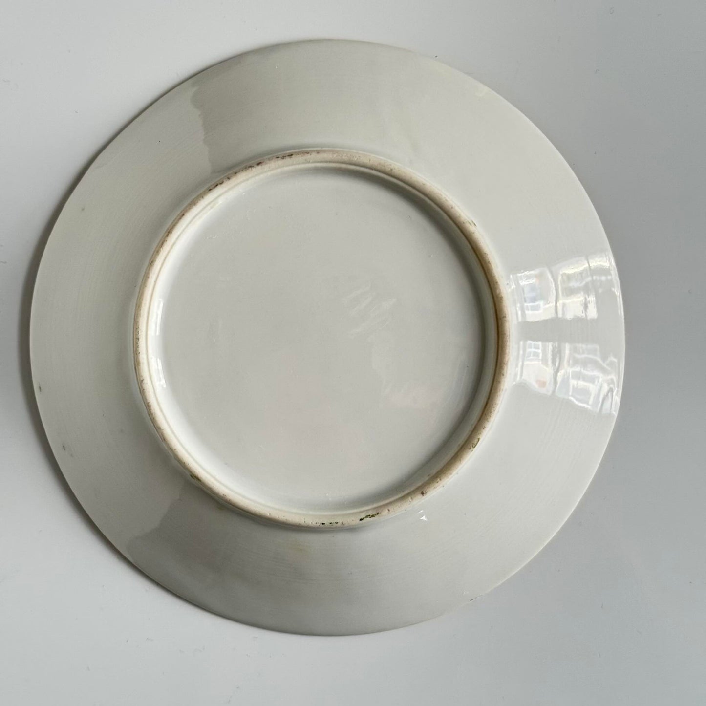 Porcelain cup and saucer set inspired by 18th-century Sèvres style, with delicate pink and green hues and gilded details.