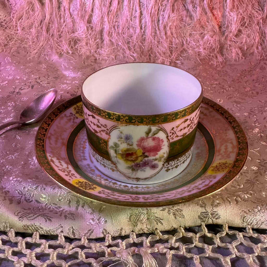 Porcelain cup and saucer set inspired by 18th-century Sèvres style, with delicate pink and green hues and gilded details.