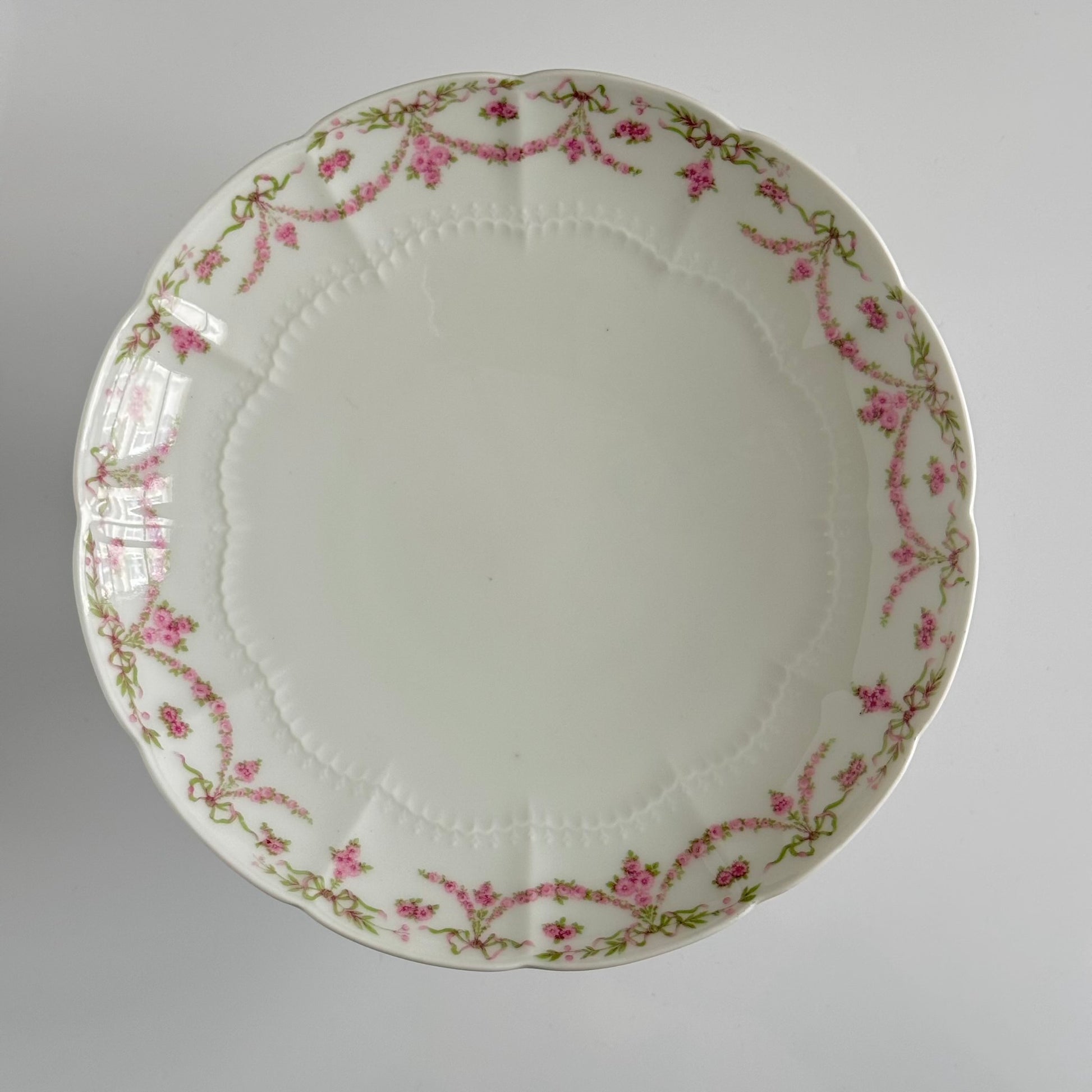 English: Ahrenfeldt Limoges porcelain compote on pedestal with ribbon and floral garland decoration, late 19th to early 20th century, France. ;
Français : Compotier en porcelaine de Limoges Ahrenfeldt sur piédouche, décor de rubans et guirlandes de fleurs, fin XIXᵉ – début XXᵉ siècle. ;
日本語: アーレンフェルト製 リモージュ磁器の脚付きコンポティエ（フルーツスタンド）。リボンとガーランドの装飾、19世紀末〜20世紀初頭 フランス。