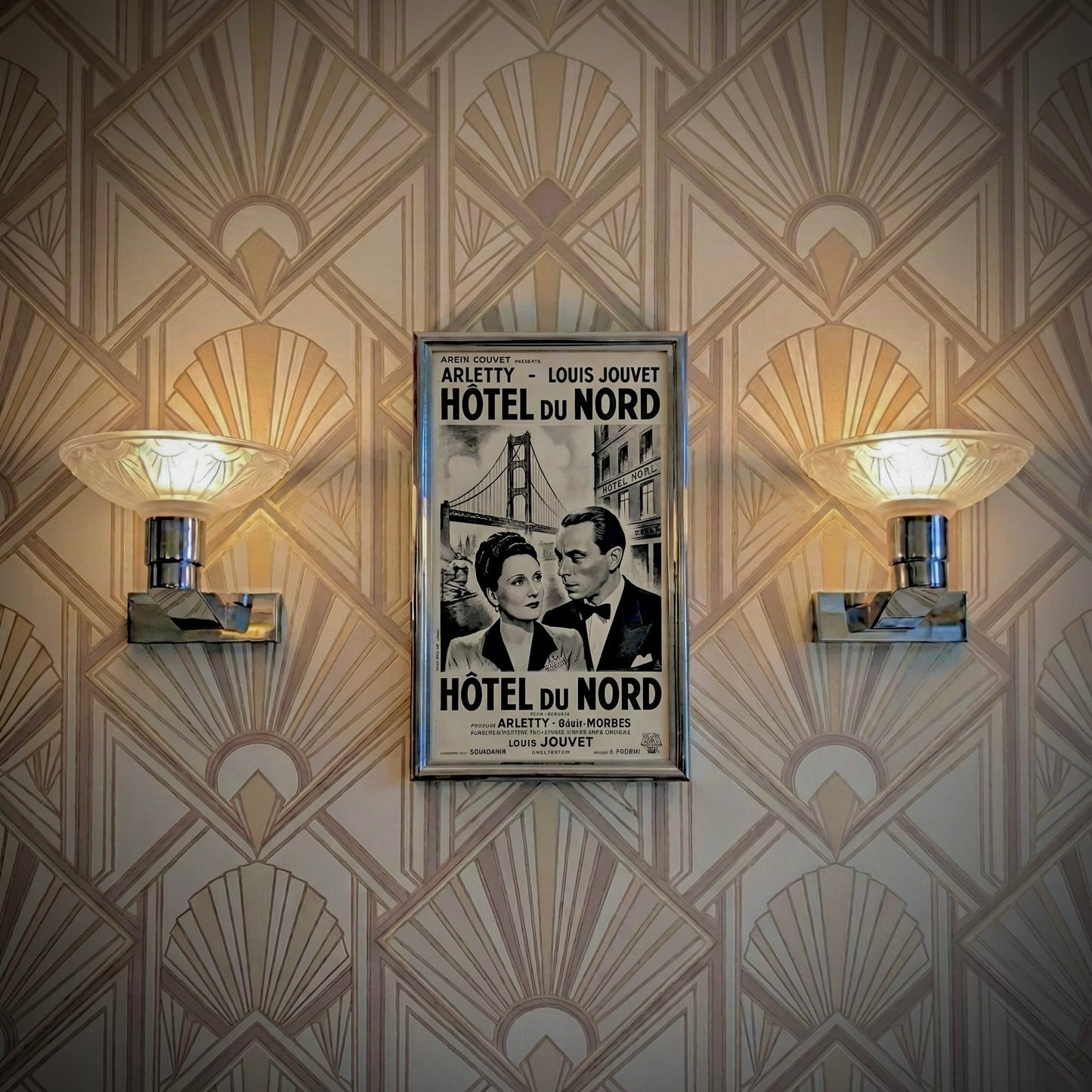 Pair of antique French Art Deco wall sconces, chromed metal and molded glass shades, early 20th century.