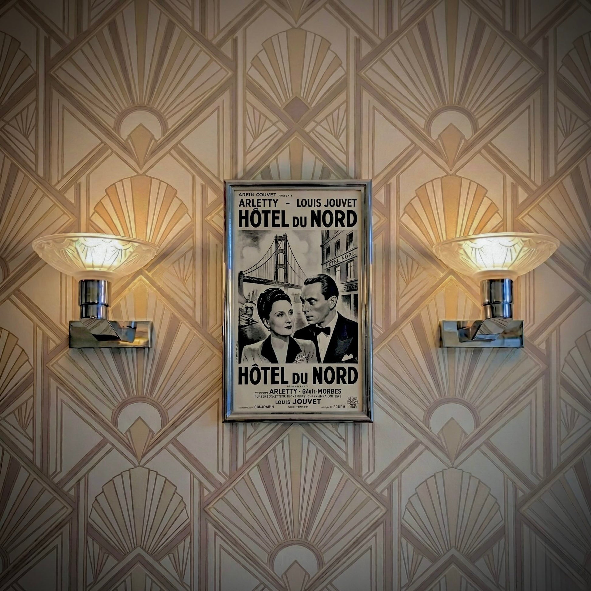 Pair of antique French Art Deco wall sconces, chromed metal and molded glass shades, early 20th century.