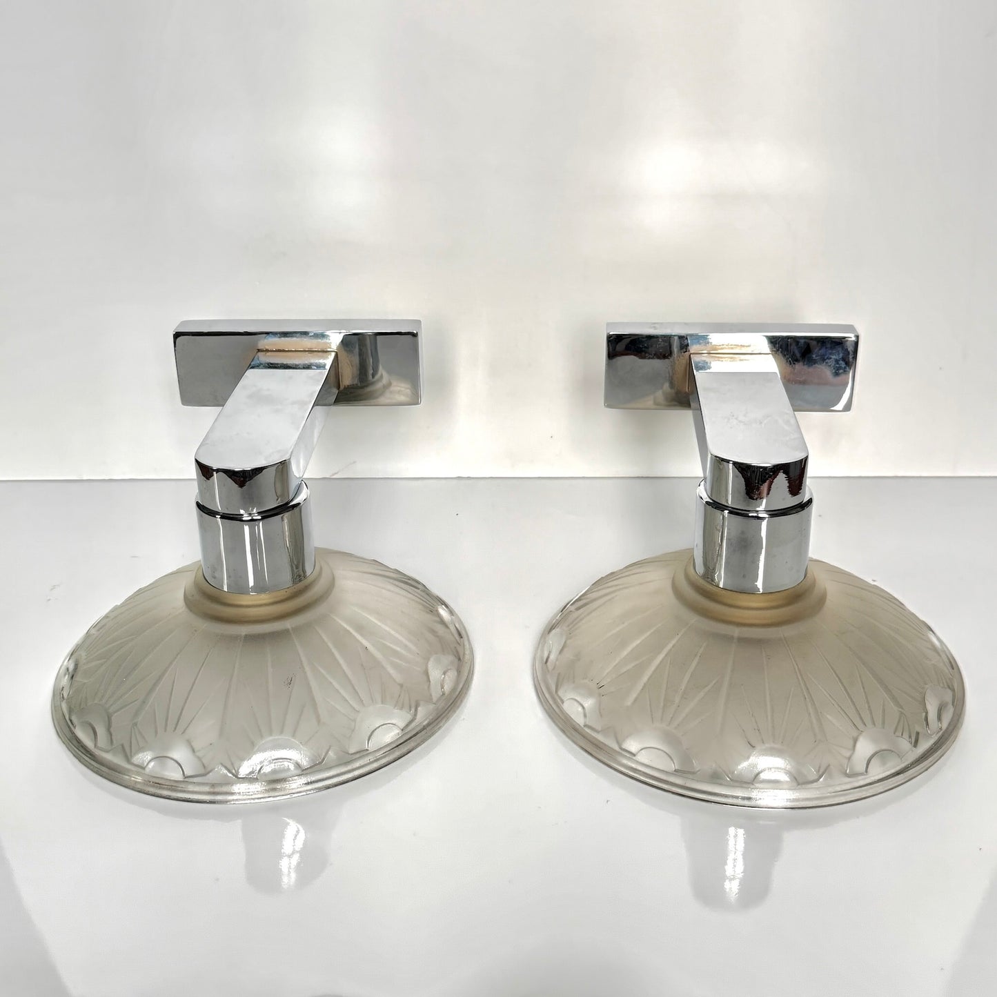 Pair of antique French Art Deco wall sconces, chromed metal and molded glass shades, early 20th century.