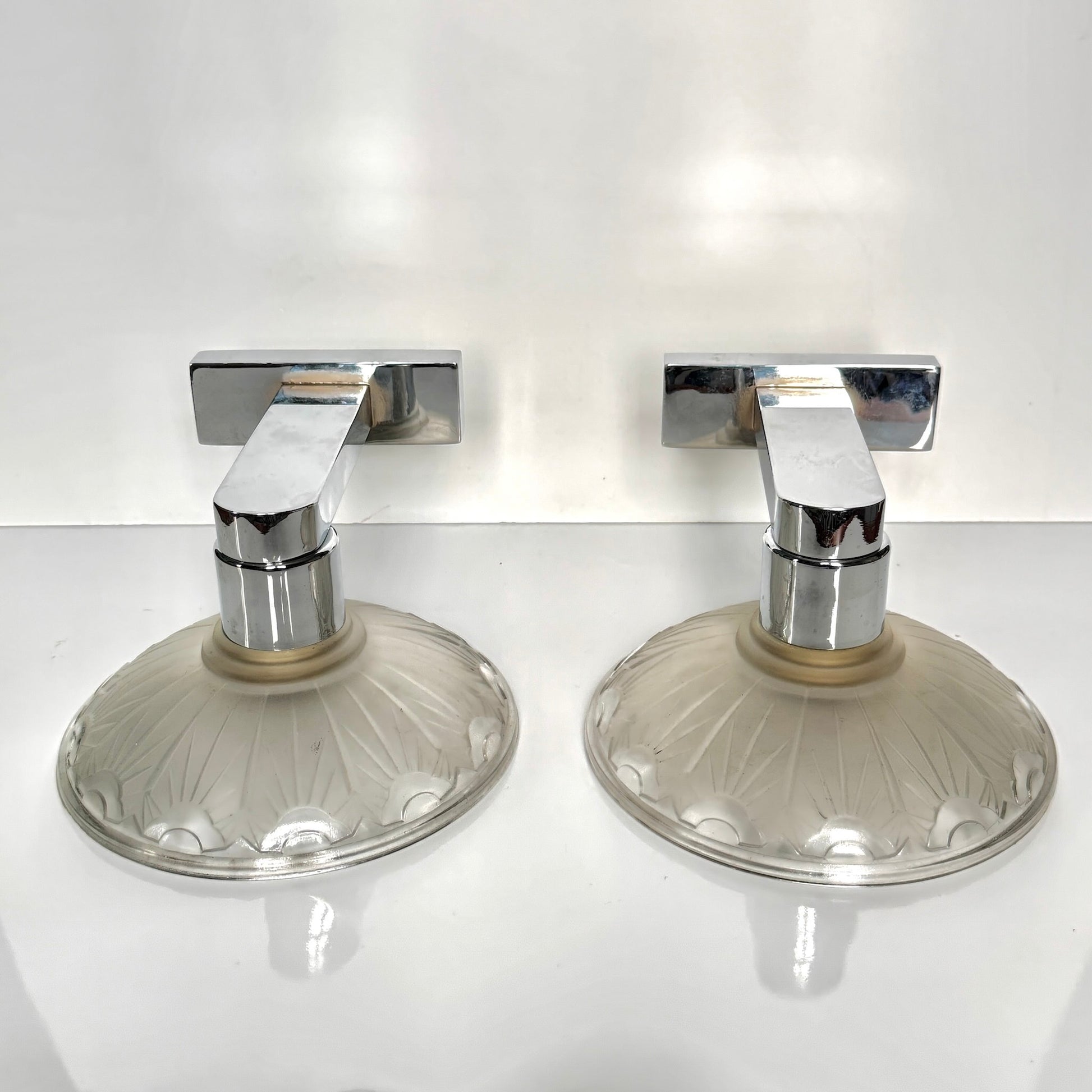 Pair of antique French Art Deco wall sconces, chromed metal and molded glass shades, early 20th century.