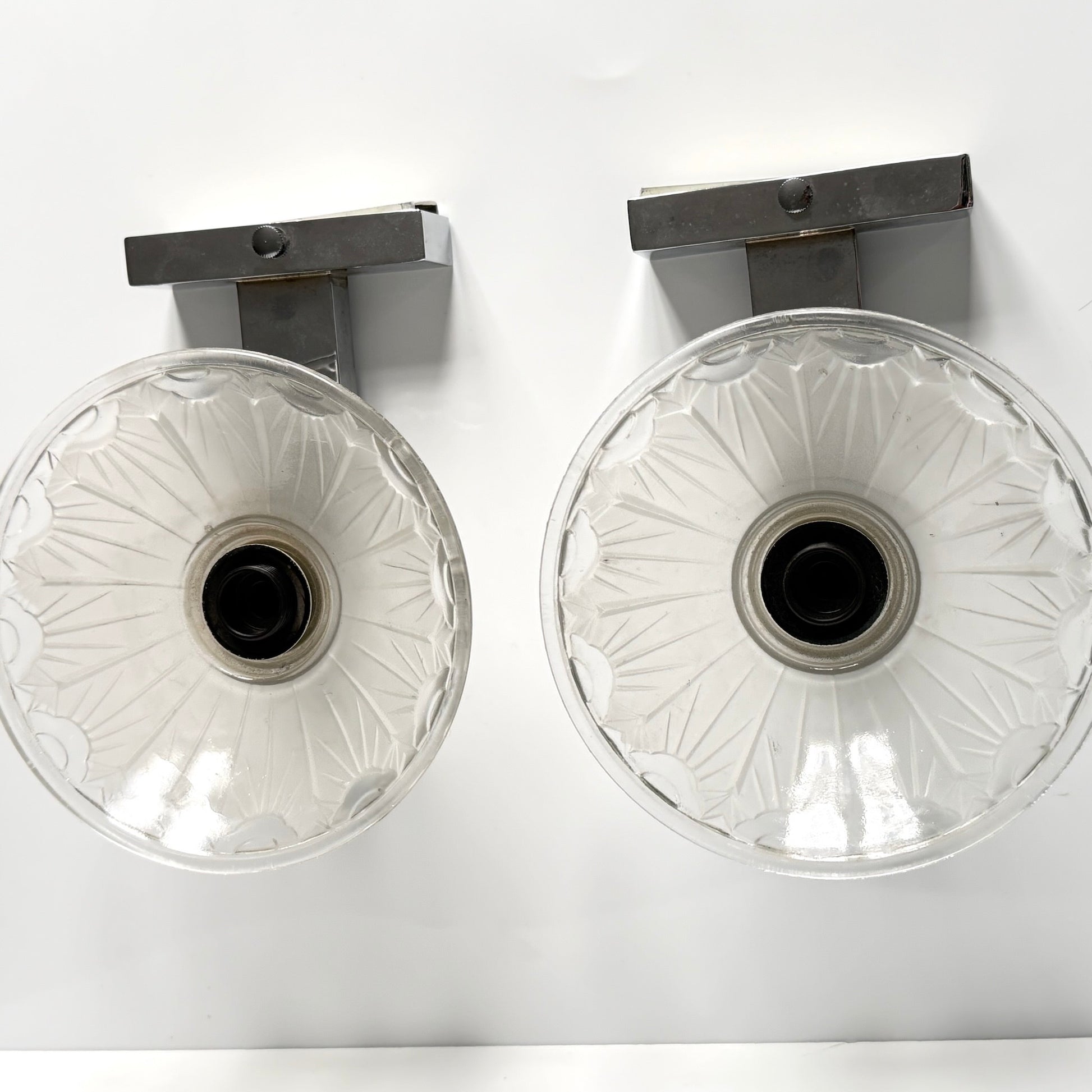 Pair of antique French Art Deco wall sconces, chromed metal and molded glass shades, early 20th century.