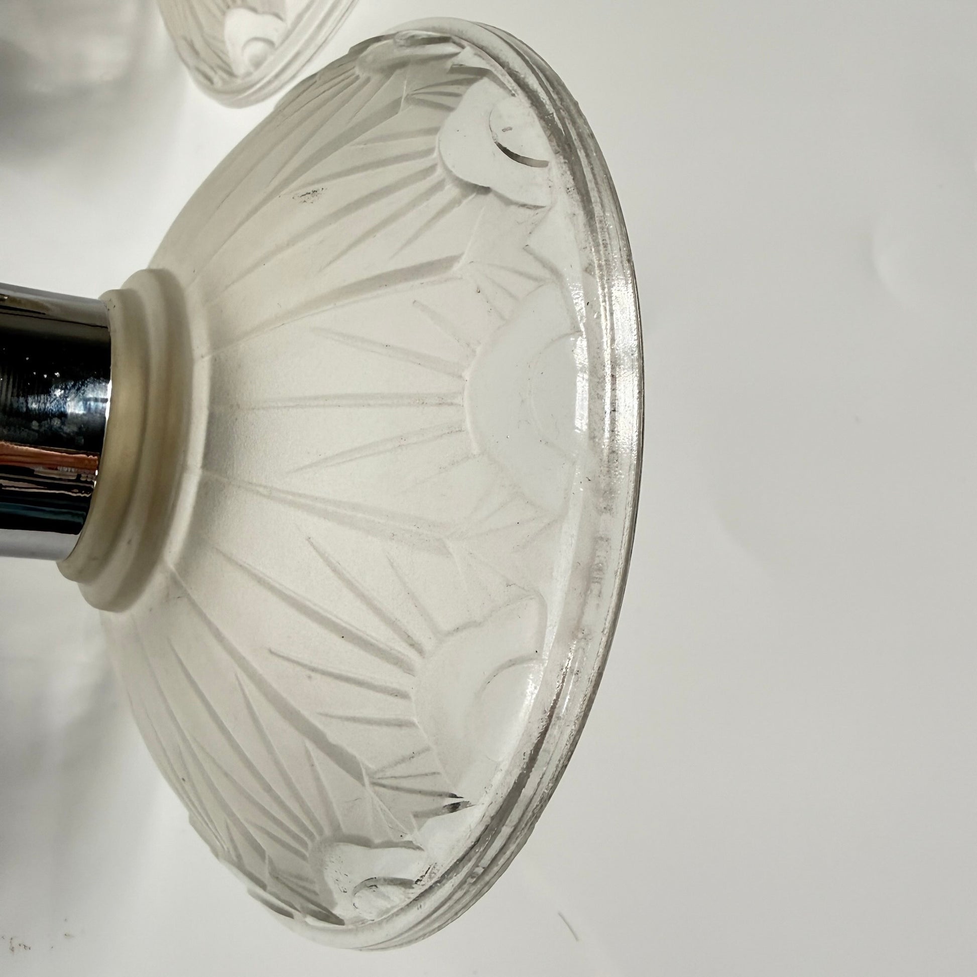 Pair of antique French Art Deco wall sconces, chromed metal and molded glass shades, early 20th century.