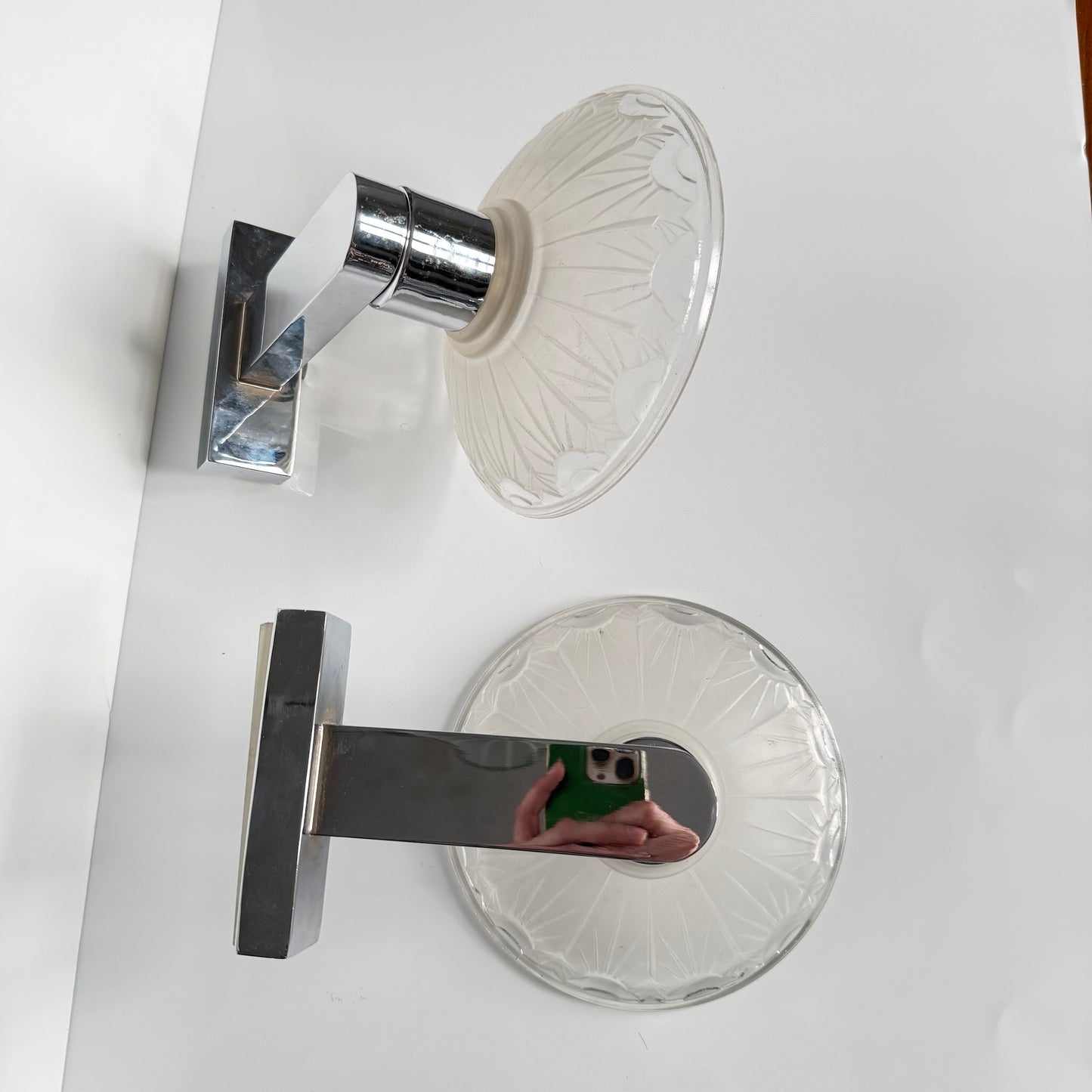 Pair of antique French Art Deco wall sconces, chromed metal and molded glass shades, early 20th century.