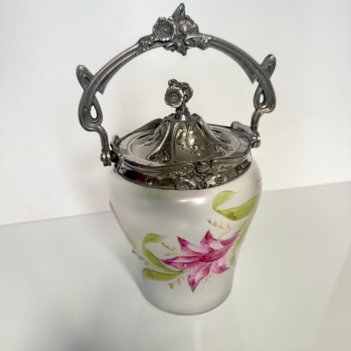 Antique Art Nouveau frosted glass biscuit barrel, decorated with a hand-painted pink flower and ornate metal mount, France.