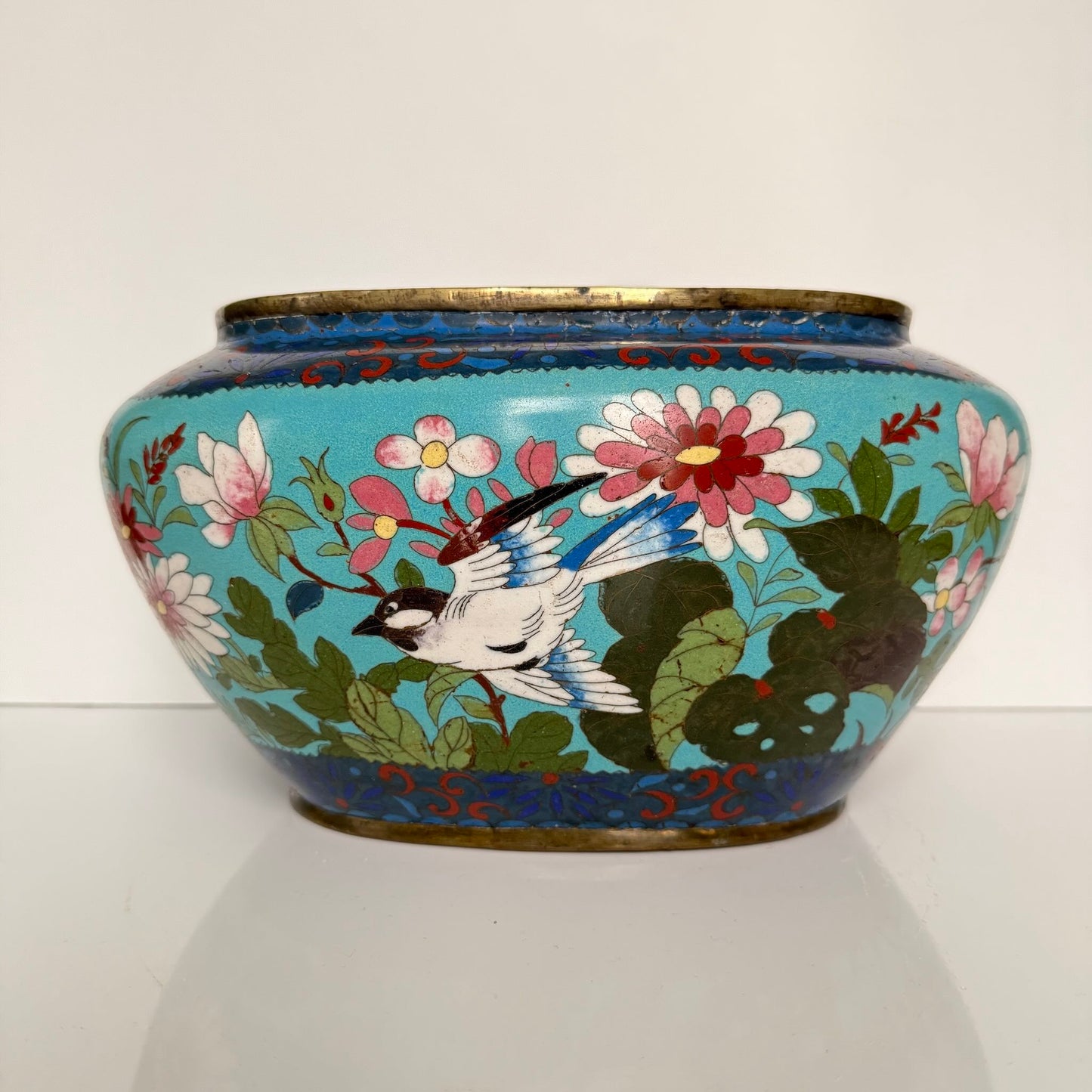 Antique Chinese cloisonné enamel jardinière, turquoise blue background with birds and butterflies, late 19th century.