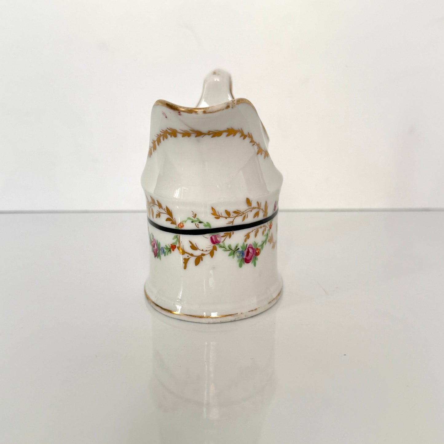 Antique Clignancourt hard-paste porcelain milk jug, hand-painted floral garlands, 18th century France.
