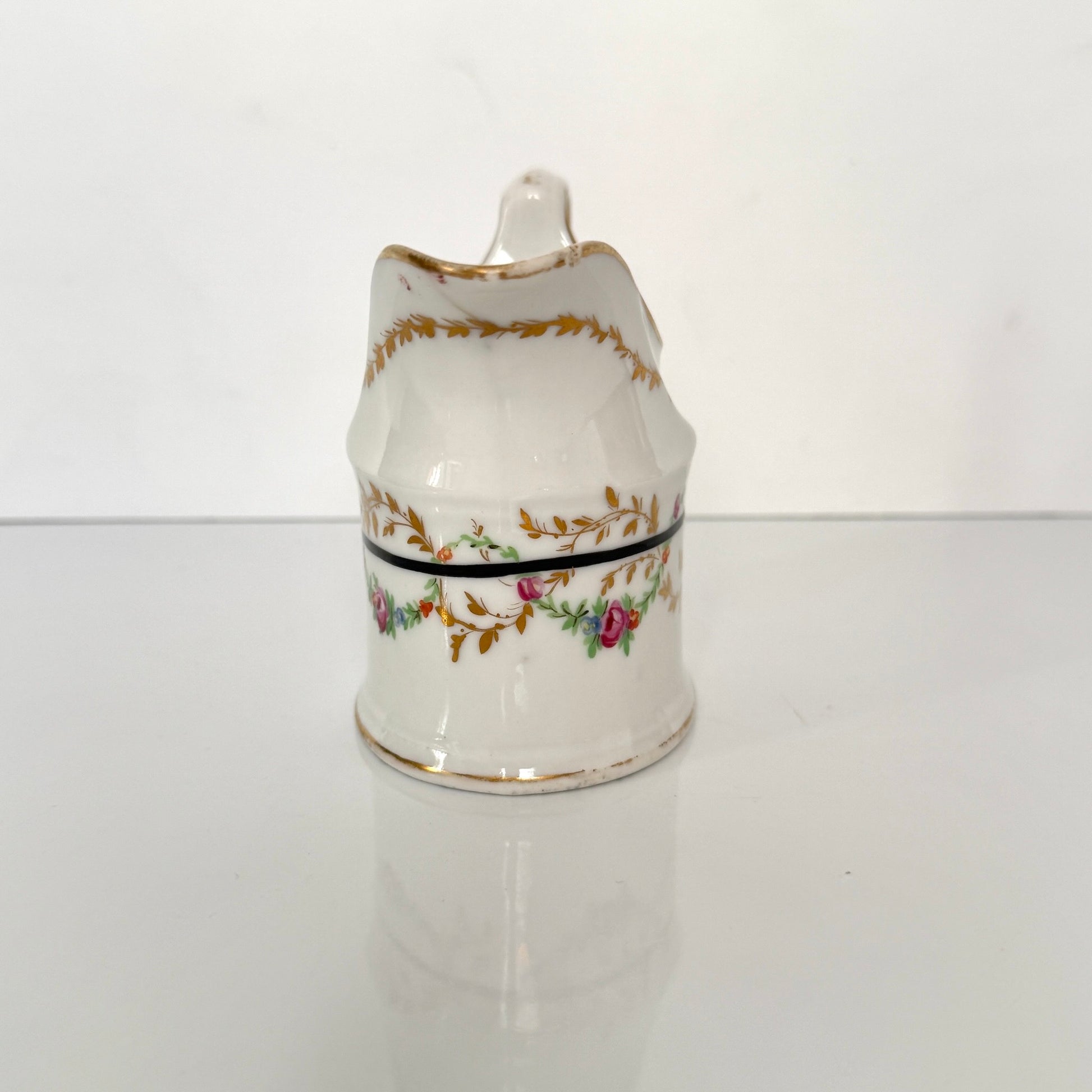 Antique Clignancourt hard-paste porcelain milk jug, hand-painted floral garlands, 18th century France.
