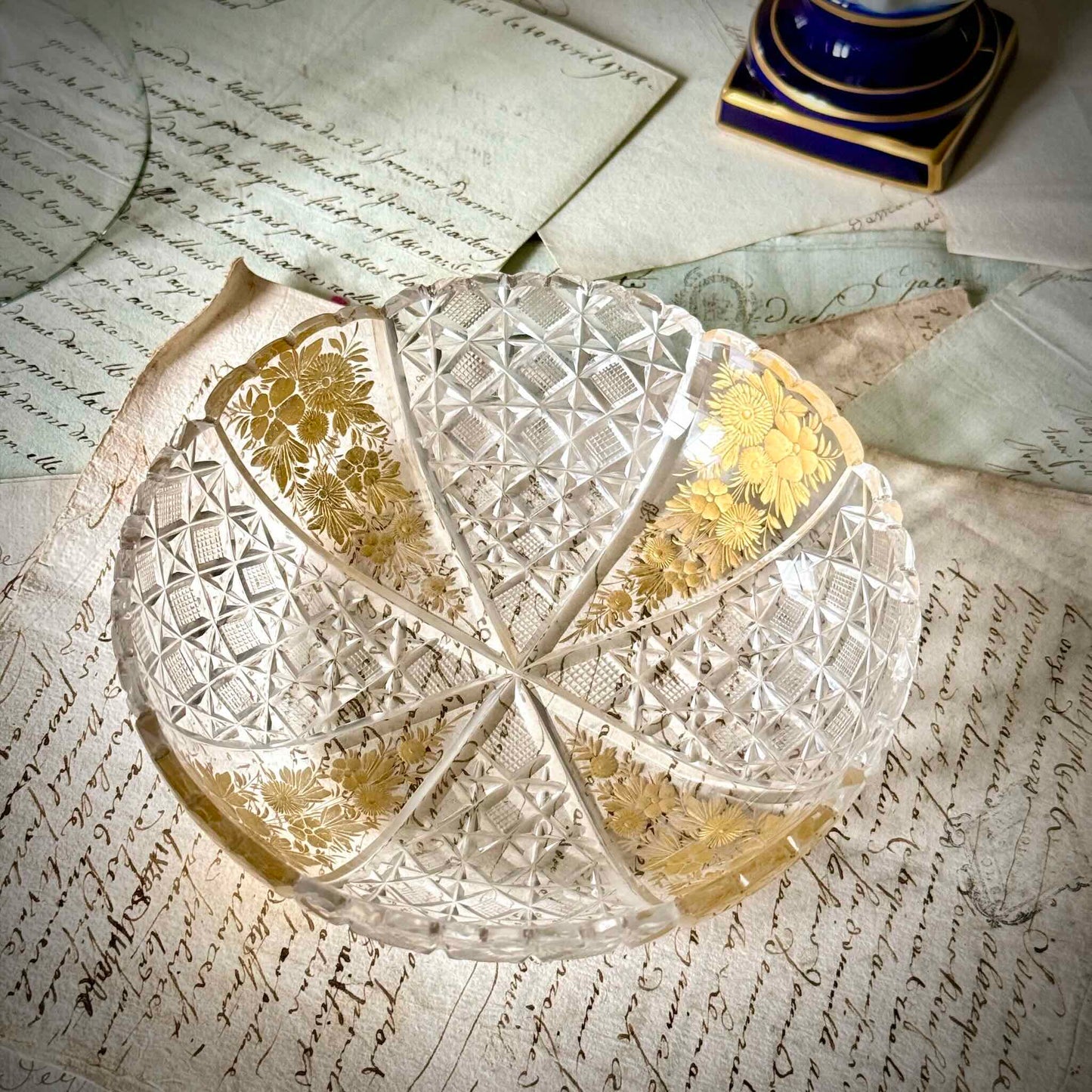 Antique French cut crystal bowl adorned with geometric patterns and gold-enhanced floral motifs, attributed to Baccarat or Saint-Louis.