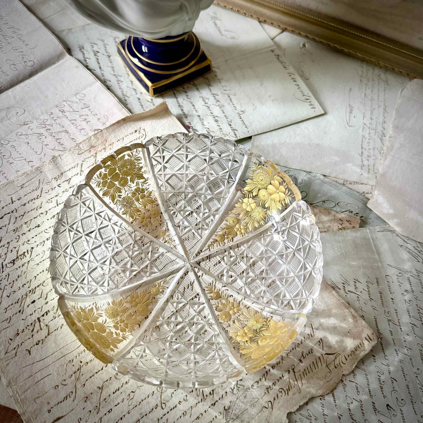 Antique French cut crystal bowl adorned with geometric patterns and gold-enhanced floral motifs, attributed to Baccarat or Saint-Louis.