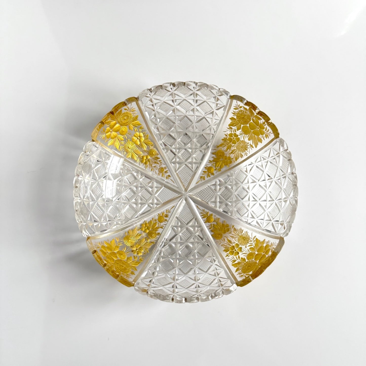 Antique French cut crystal bowl adorned with geometric patterns and gold-enhanced floral motifs, attributed to Baccarat or Saint-Louis.