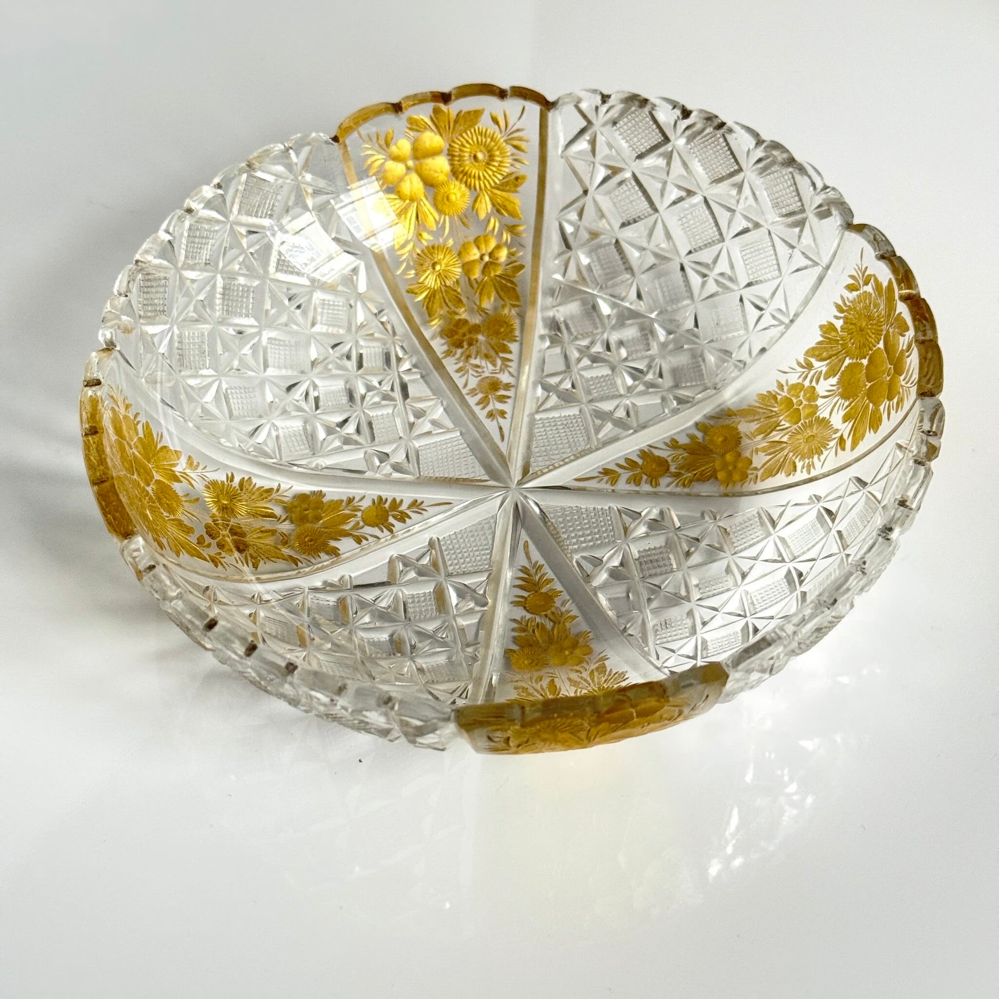 Antique French cut crystal bowl adorned with geometric patterns and gold-enhanced floral motifs, attributed to Baccarat or Saint-Louis.
