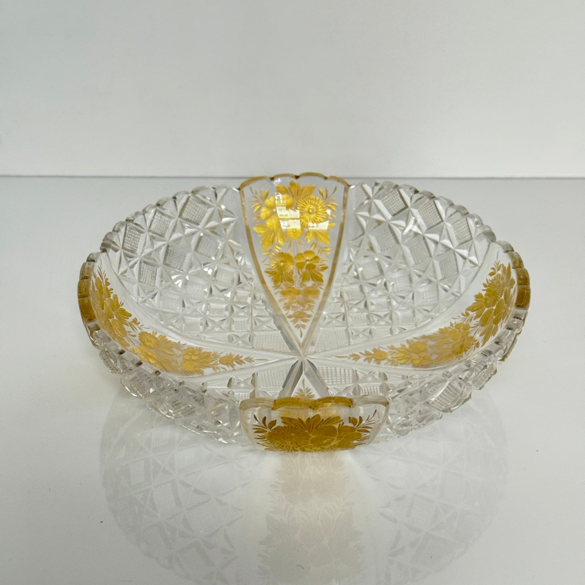 Antique French cut crystal bowl adorned with geometric patterns and gold-enhanced floral motifs, attributed to Baccarat or Saint-Louis.