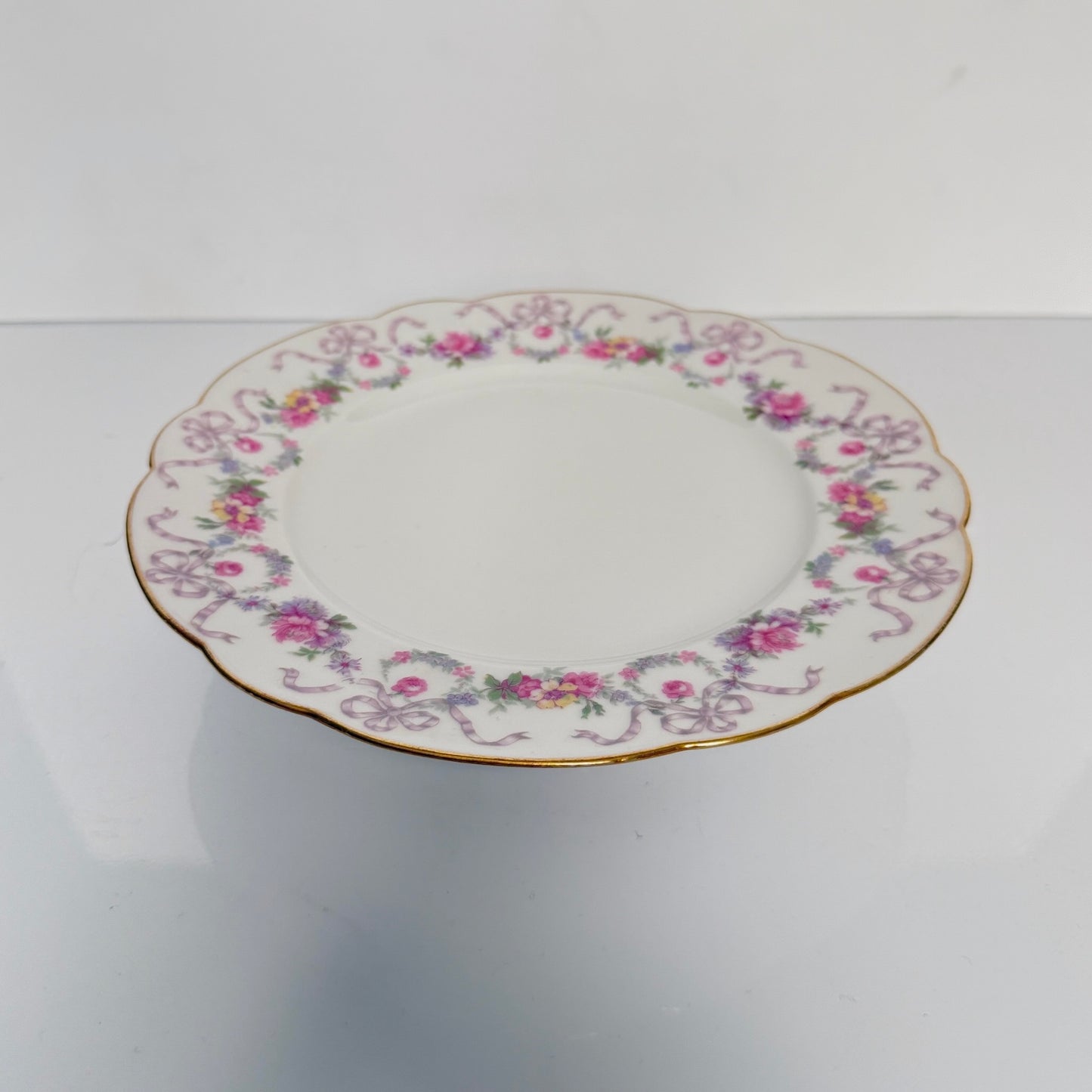Antique Limoges porcelain footed cake stand, floral garlands and ribbons, D&C Old Bernardaud, late 19th century France.