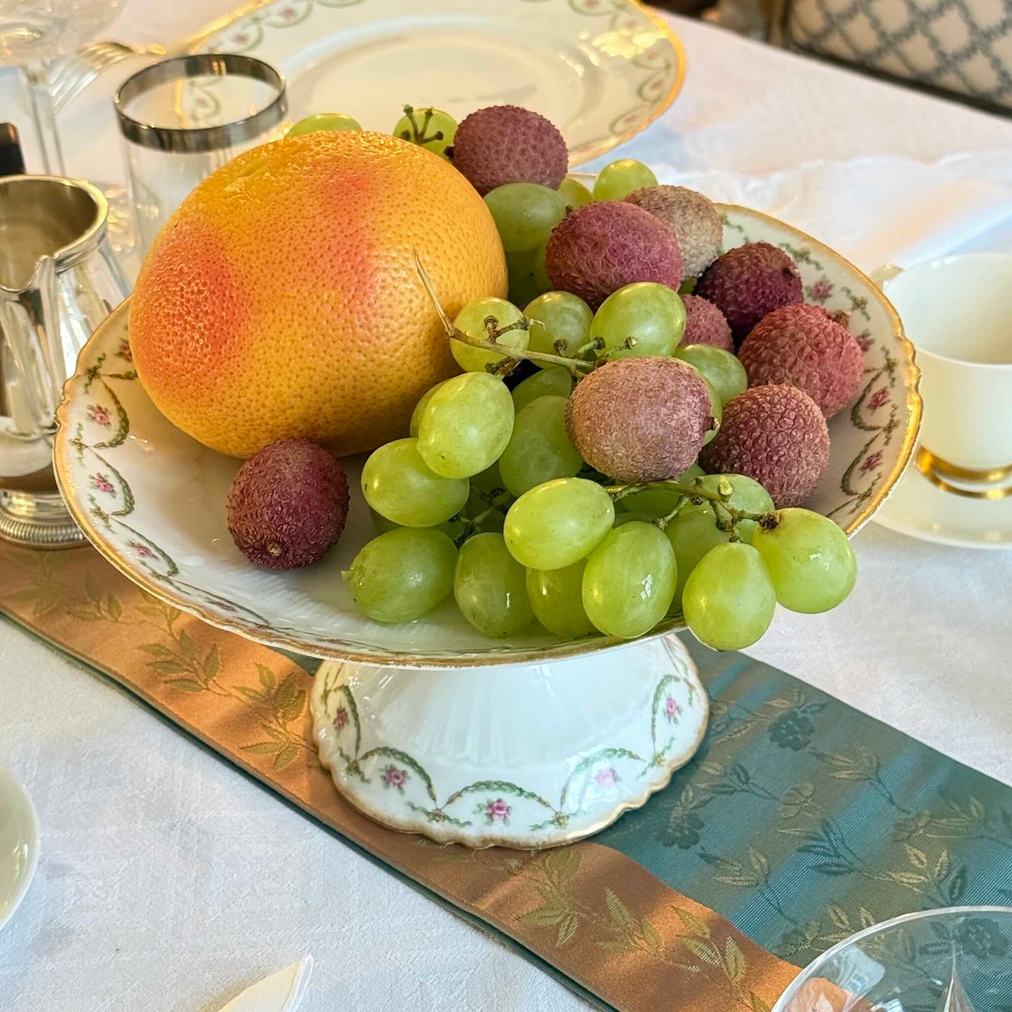 Antique Limoges porcelain compotier on pedestal, pink rose floral pattern and gold trim, late 19th or early 20th century France.