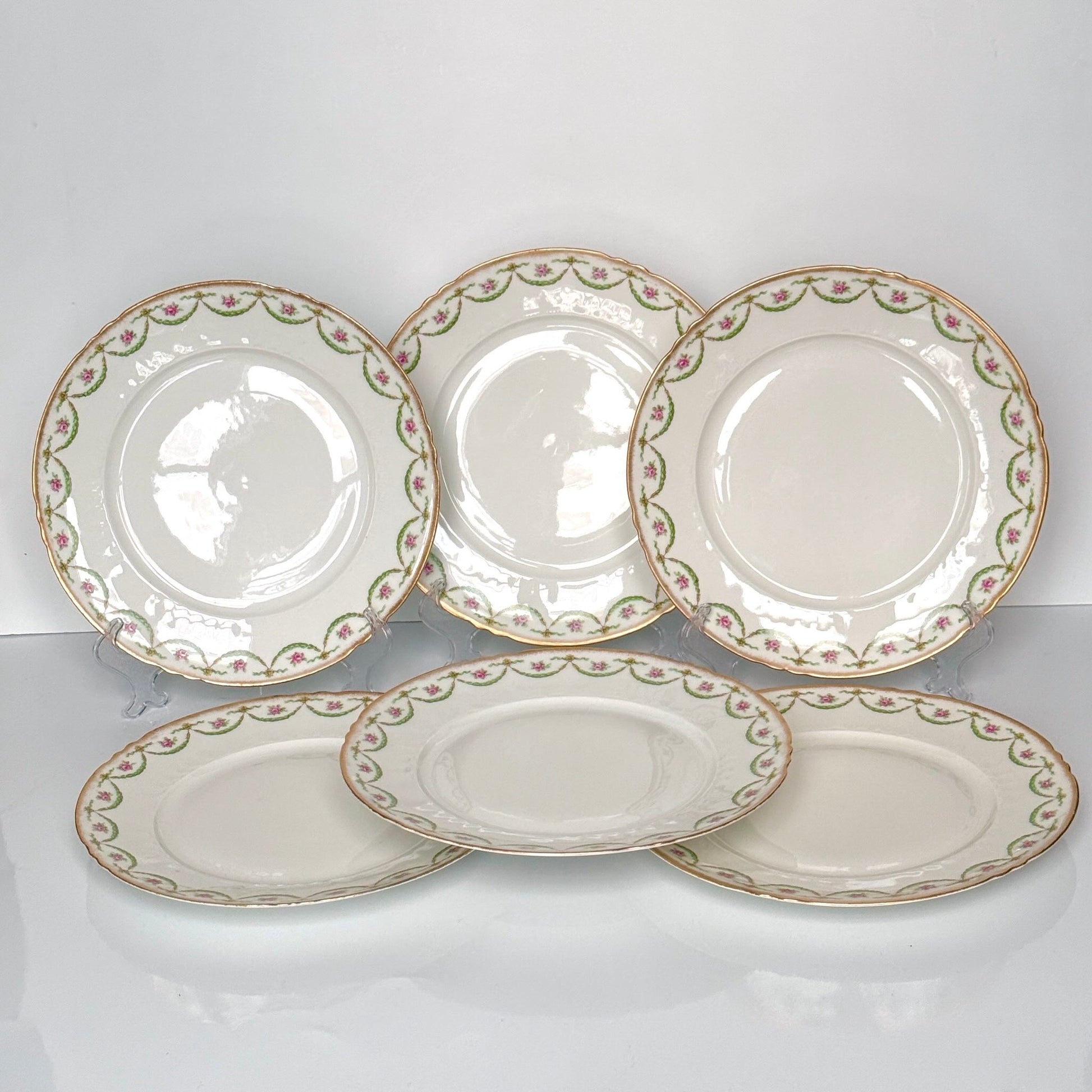 Antique Limoges porcelain dessert plate with pink rose floral pattern and gold trim, late 19th or early 20th century France.