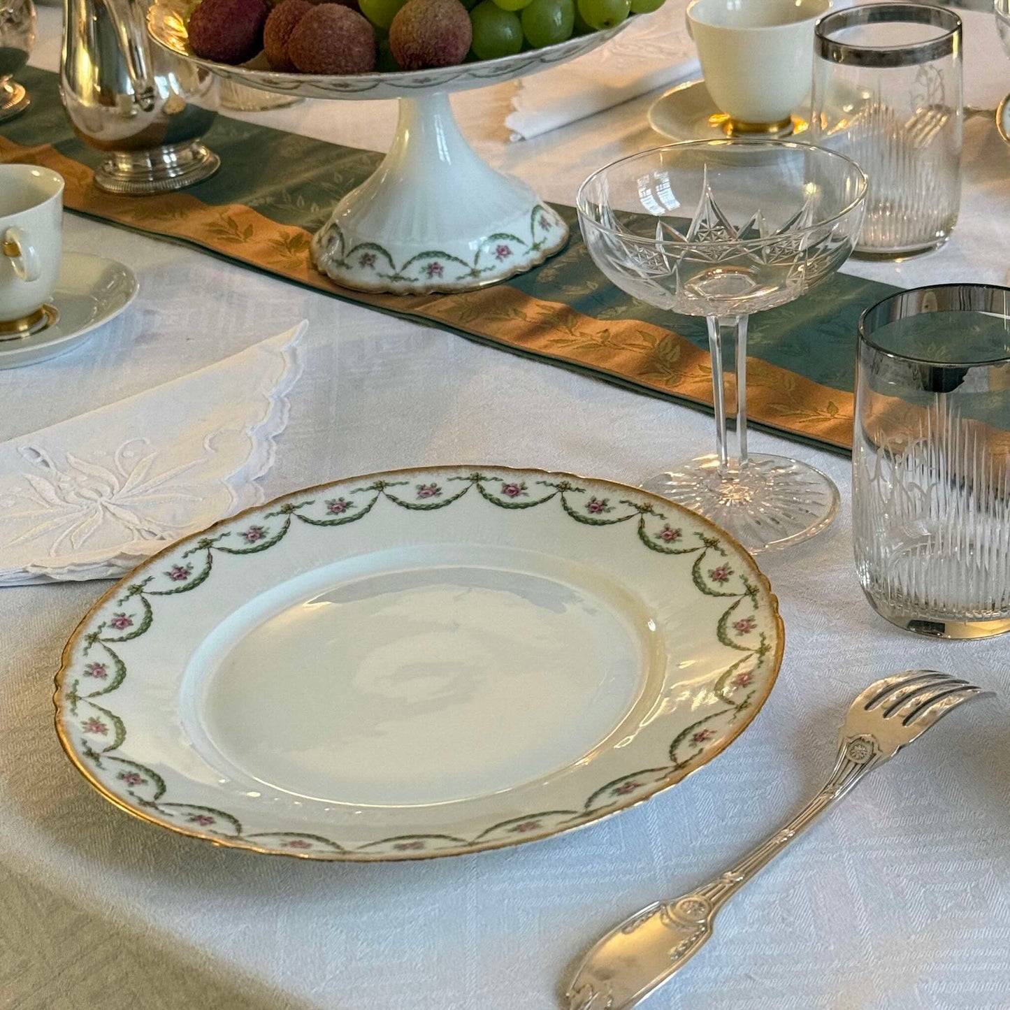 Antique Limoges porcelain dessert plate with pink rose floral pattern and gold trim, late 19th or early 20th century France.