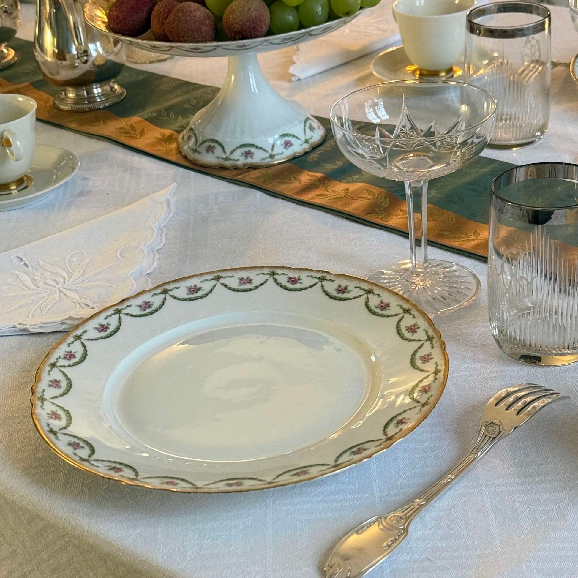 Antique Limoges porcelain dessert plate with pink rose floral pattern and gold trim, late 19th or early 20th century France.