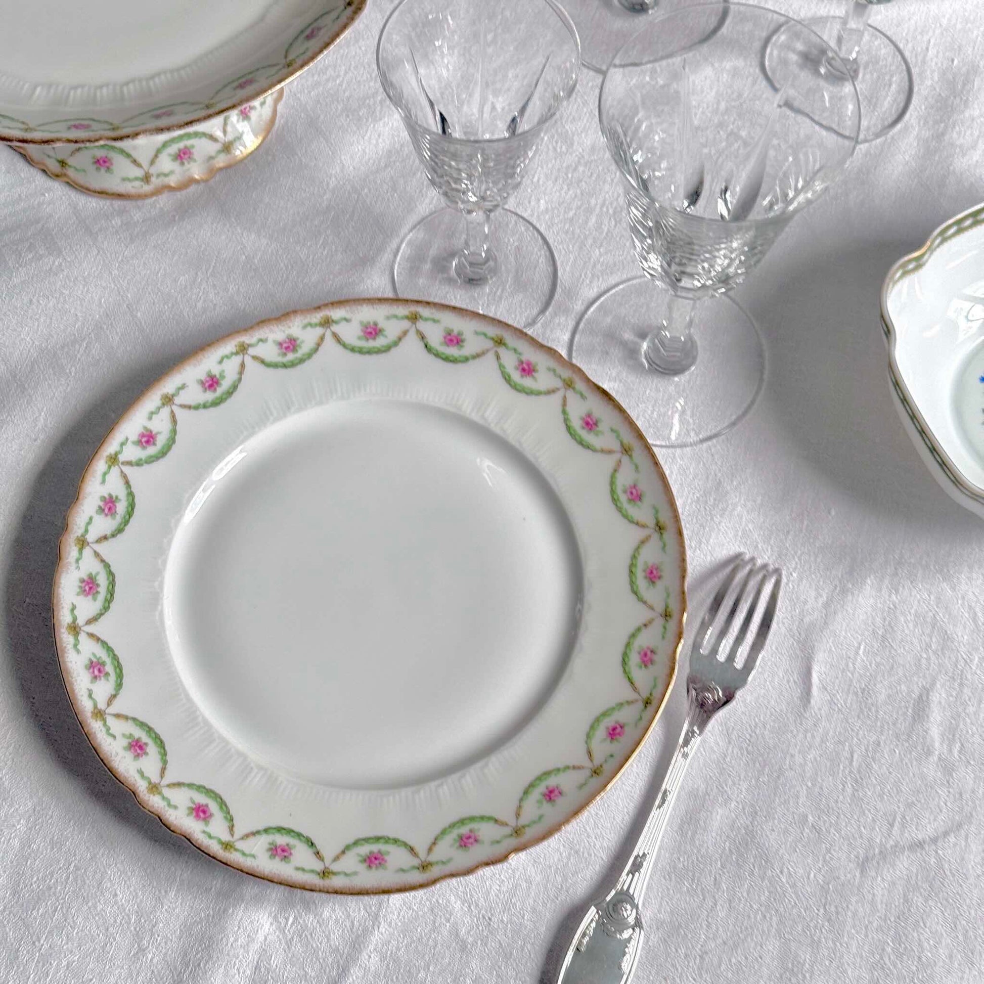 Antique Limoges porcelain dessert plate with pink rose floral pattern and gold trim, late 19th or early 20th century France.