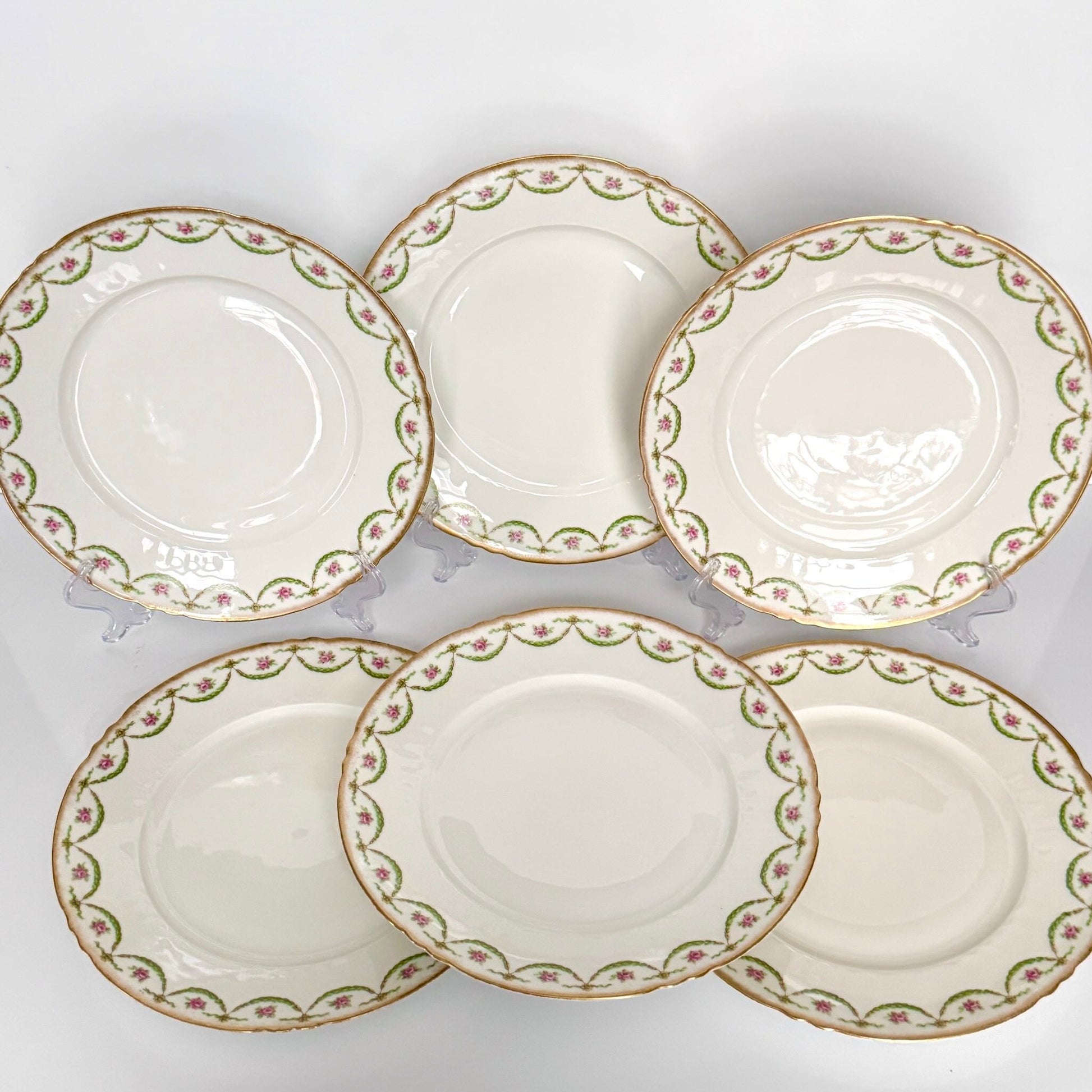 Antique Limoges porcelain dessert plate with pink rose floral pattern and gold trim, late 19th or early 20th century France.