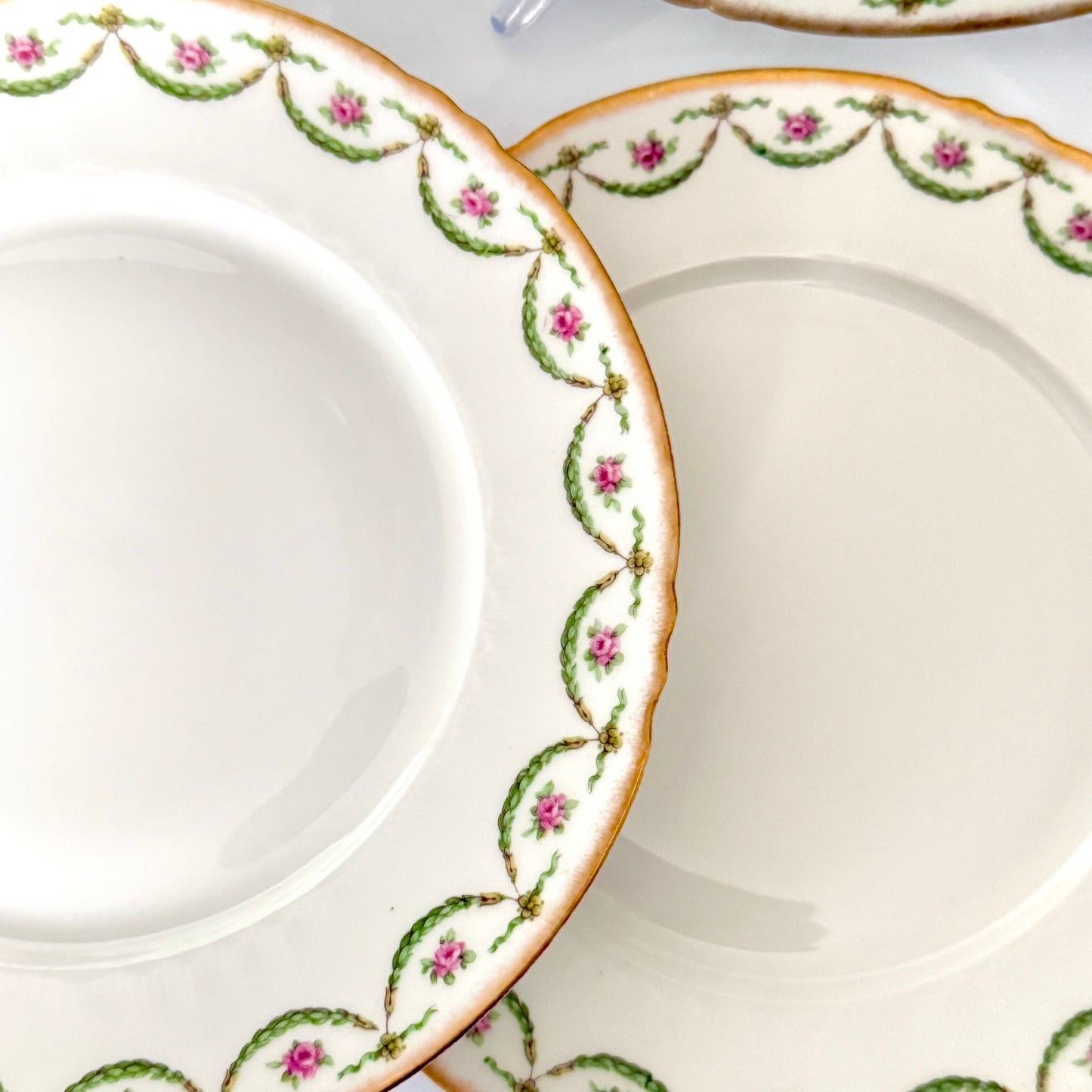 Antique Limoges porcelain dessert plate with pink rose floral pattern and gold trim, late 19th or early 20th century France.