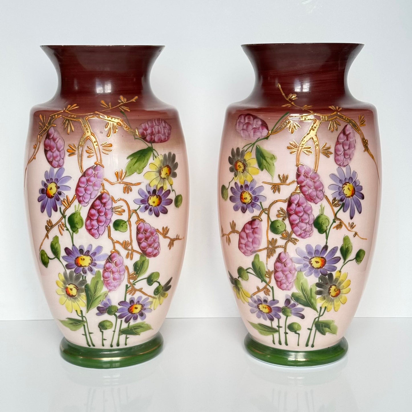 Pair of antique French opaline glass vases with pink and plum gradient, adorned with hand-painted floral motifs and thick gold enamel, 19th century.