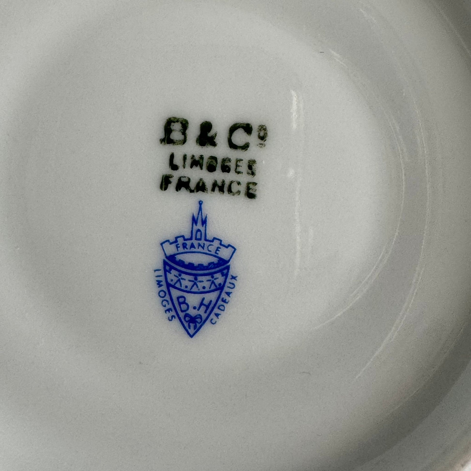 English: Bernardaud Limoges porcelain cup and saucer set, blue ribbon and rose garland design, early 20th century, signed B.H Cadeaux and B&Co; 日本語: ベルナルド・リモージュのポーセリン製カップ＆ソーサー、ブルーリボンとバラのガーランド模様、20世紀前期製造、B.H CadeauxおよびB&Coのサイン入り; Français: Ensemble tasse et soucoupe en porcelaine de Limoges par Bernardaud, décor de ruban bleu et guirlande de roses, début du XXe siècle, signé B.H Cadeaux et B&Co.