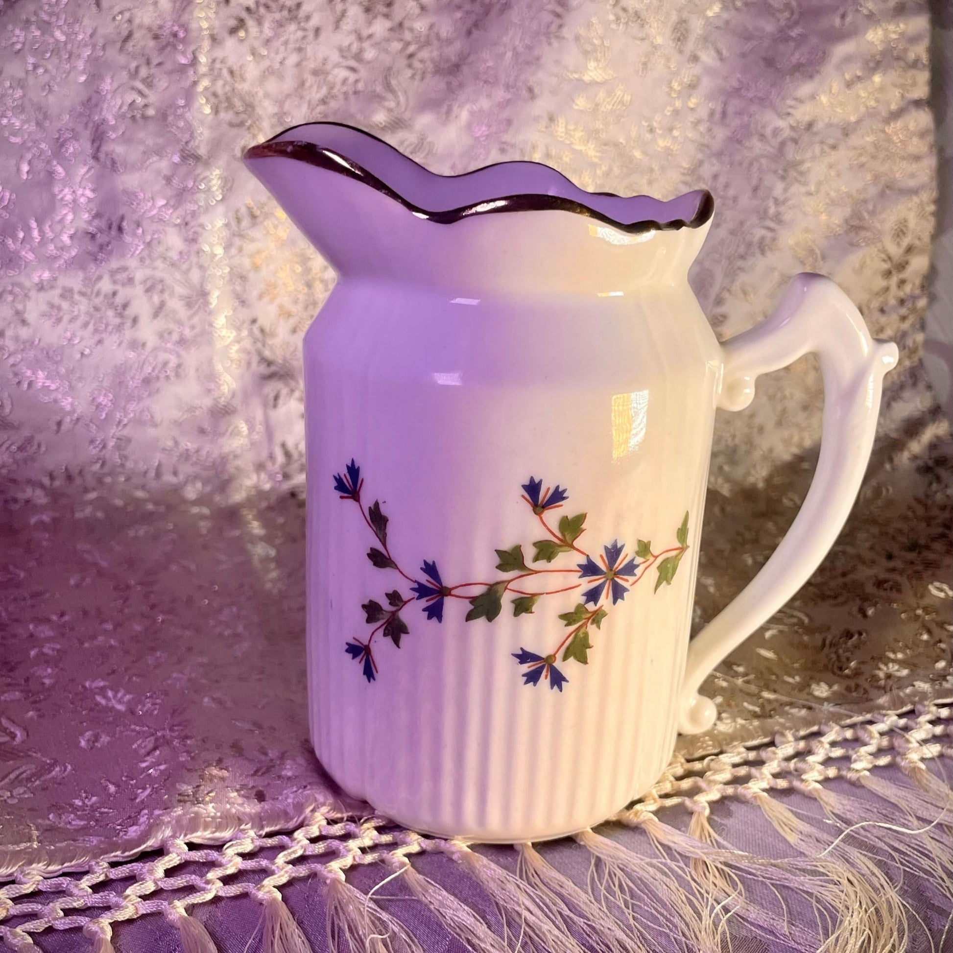 Charming creamer featuring a beautiful cornflower motif, inspired by the designs favored by 18th-century French nobility. Known to have been used in Sèvres porcelain tableware owned by Marie Antoinette.