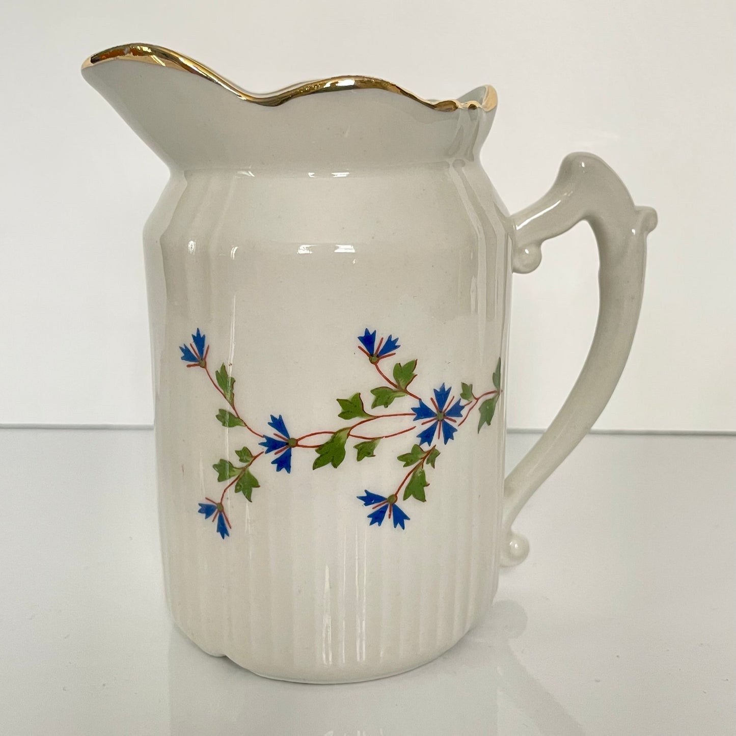Charming creamer featuring a beautiful cornflower motif, inspired by the designs favored by 18th-century French nobility. Known to have been used in Sèvres porcelain tableware owned by Marie Antoinette.