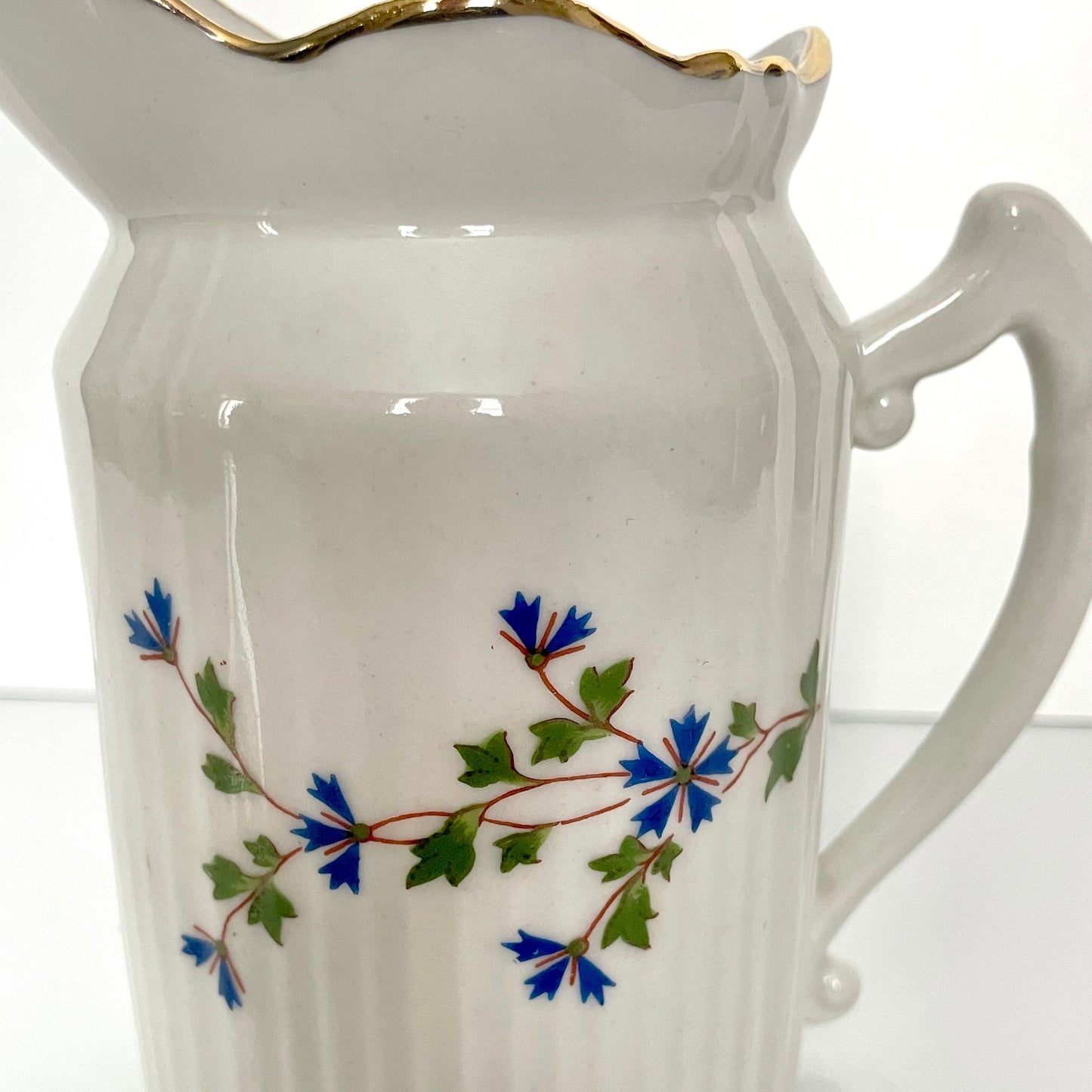 Charming creamer featuring a beautiful cornflower motif, inspired by the designs favored by 18th-century French nobility. Known to have been used in Sèvres porcelain tableware owned by Marie Antoinette.