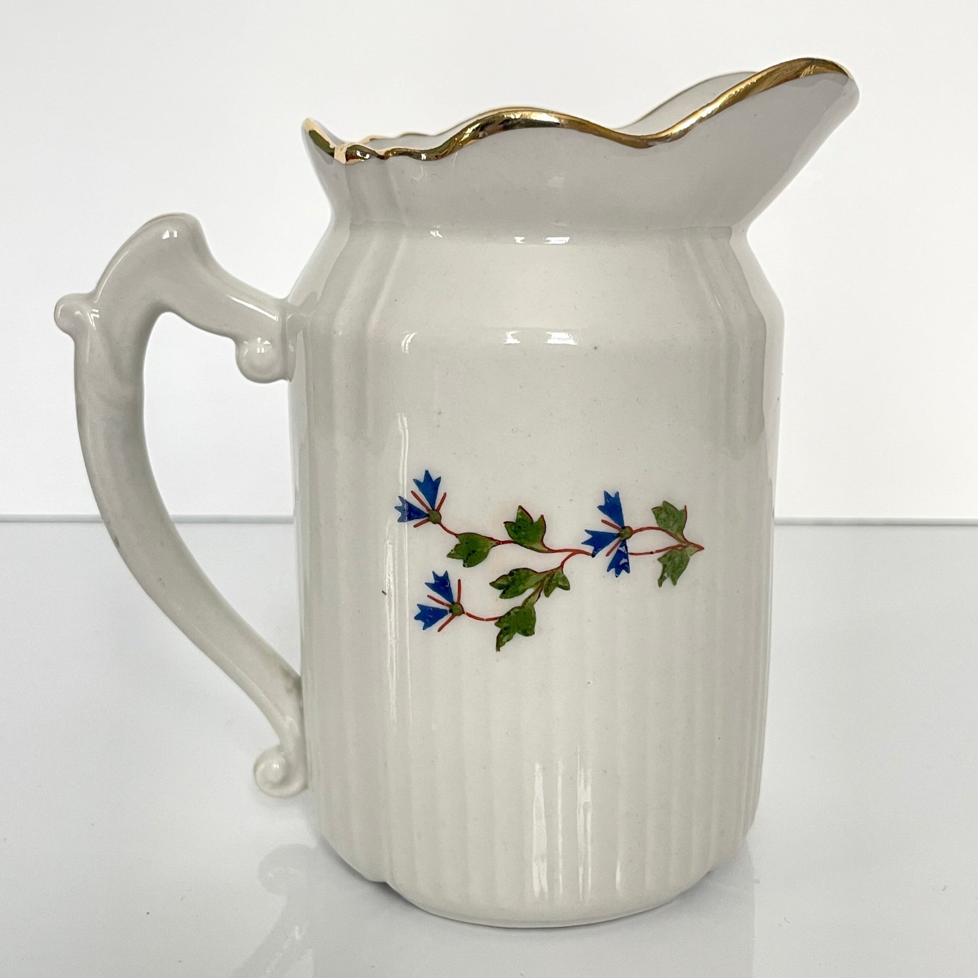 Charming creamer featuring a beautiful cornflower motif, inspired by the designs favored by 18th-century French nobility. Known to have been used in Sèvres porcelain tableware owned by Marie Antoinette.
