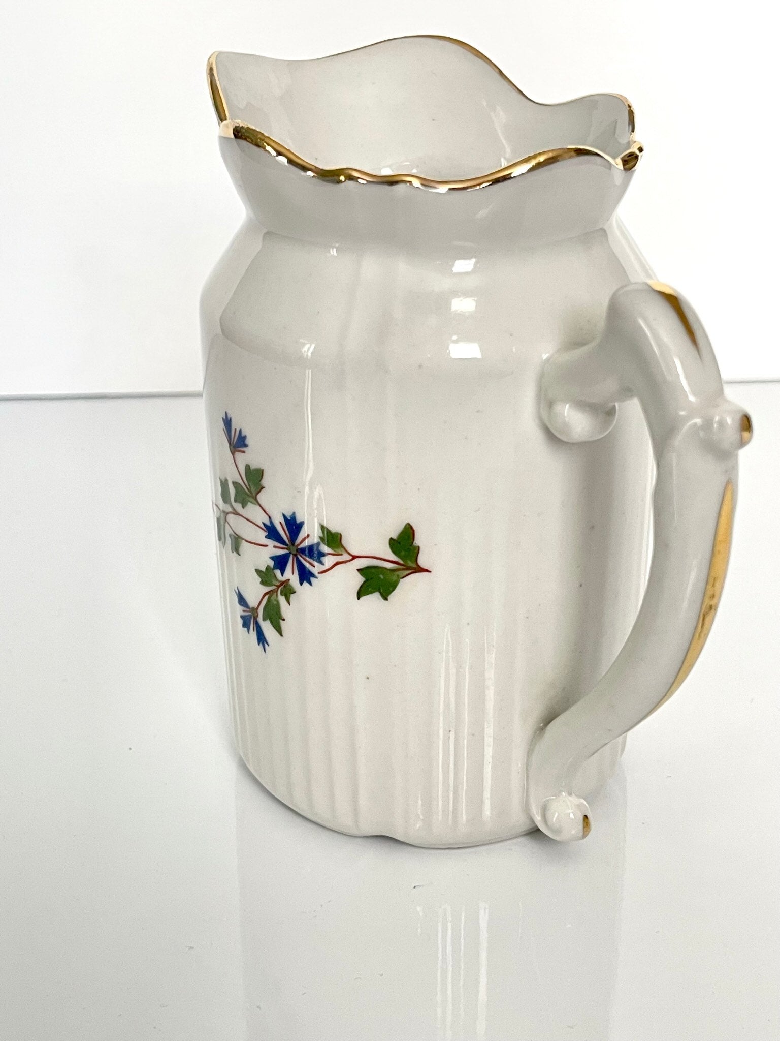 Charming creamer featuring a beautiful cornflower motif, inspired by the designs favored by 18th-century French nobility. Known to have been used in Sèvres porcelain tableware owned by Marie Antoinette.