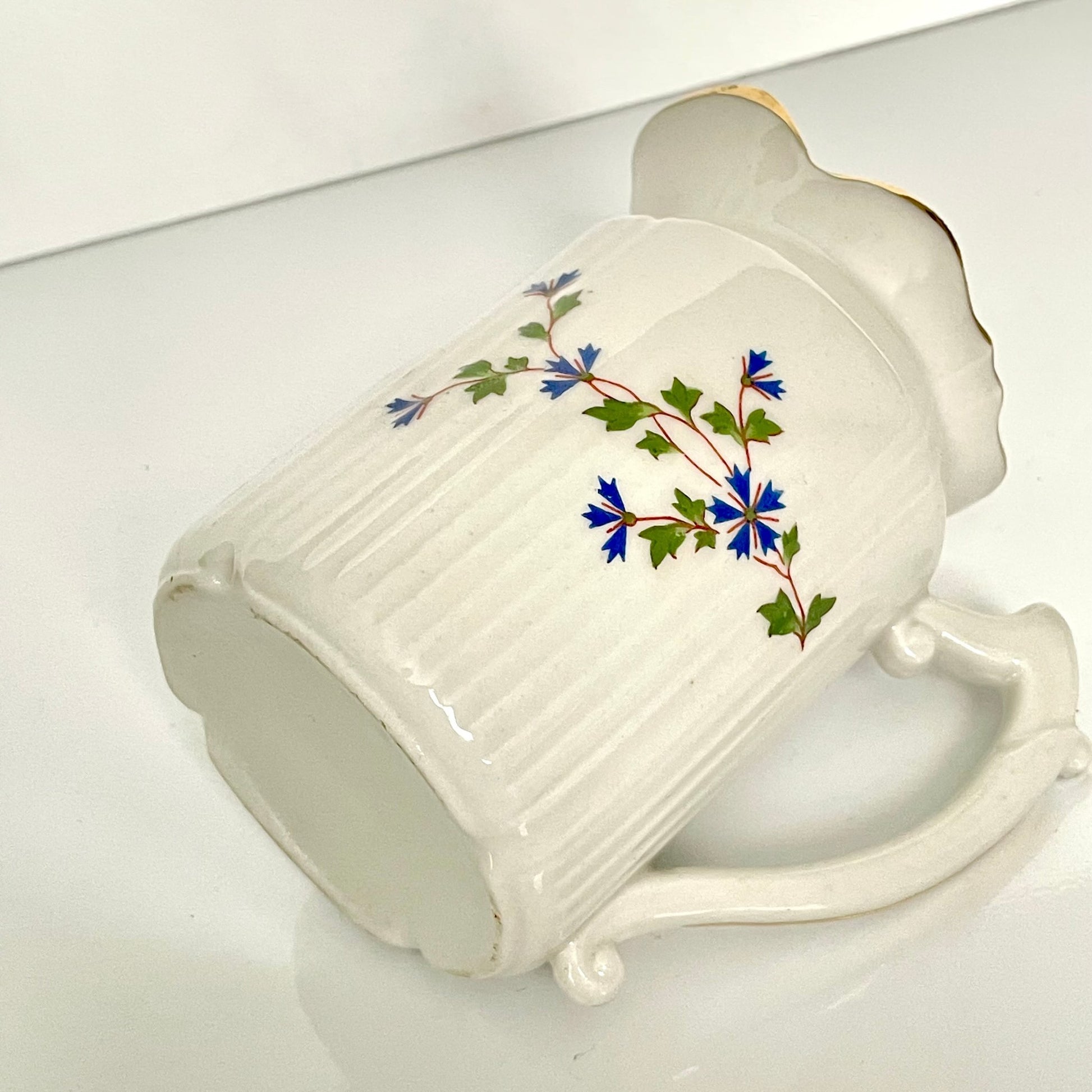 Charming creamer featuring a beautiful cornflower motif, inspired by the designs favored by 18th-century French nobility. Known to have been used in Sèvres porcelain tableware owned by Marie Antoinette.