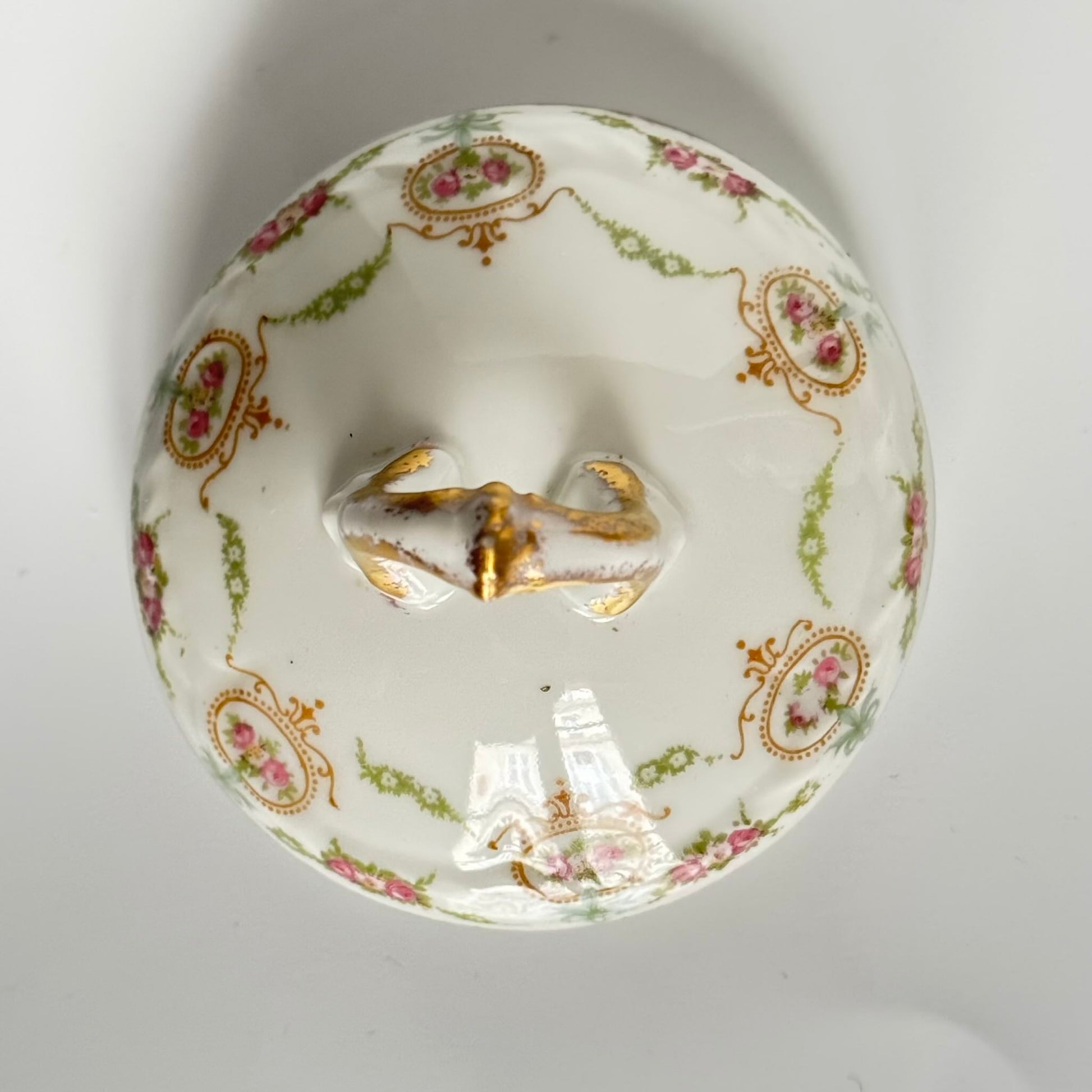 Limoges porcelain tea/coffee pot and sugar pot set with a floral and ribbon design, exuding elegance.