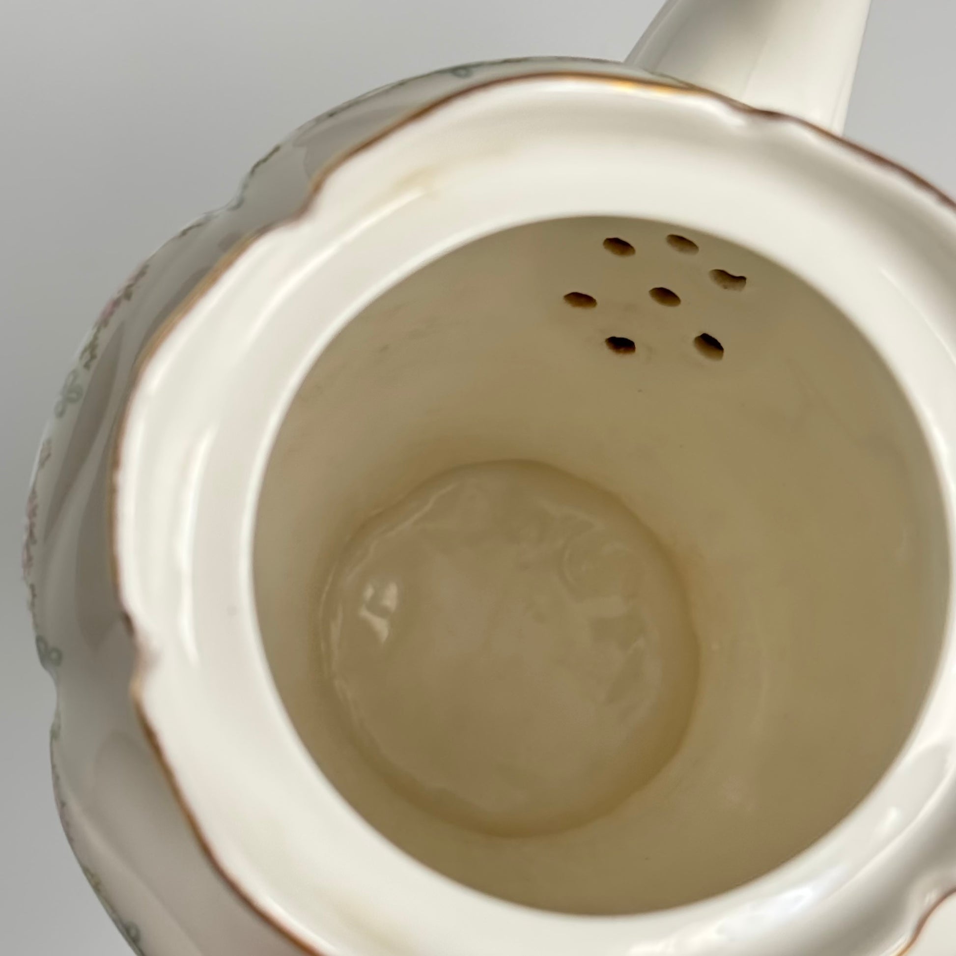 Limoges porcelain tea/coffee pot and sugar pot set with a floral and ribbon design, exuding elegance.