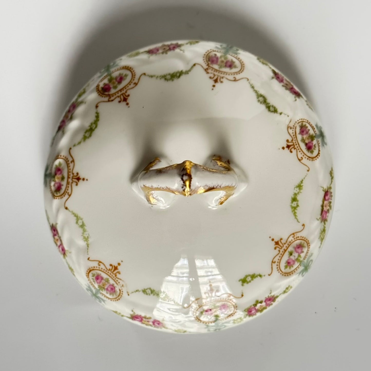 Limoges porcelain tea/coffee pot and sugar pot set with a floral and ribbon design, exuding elegance.