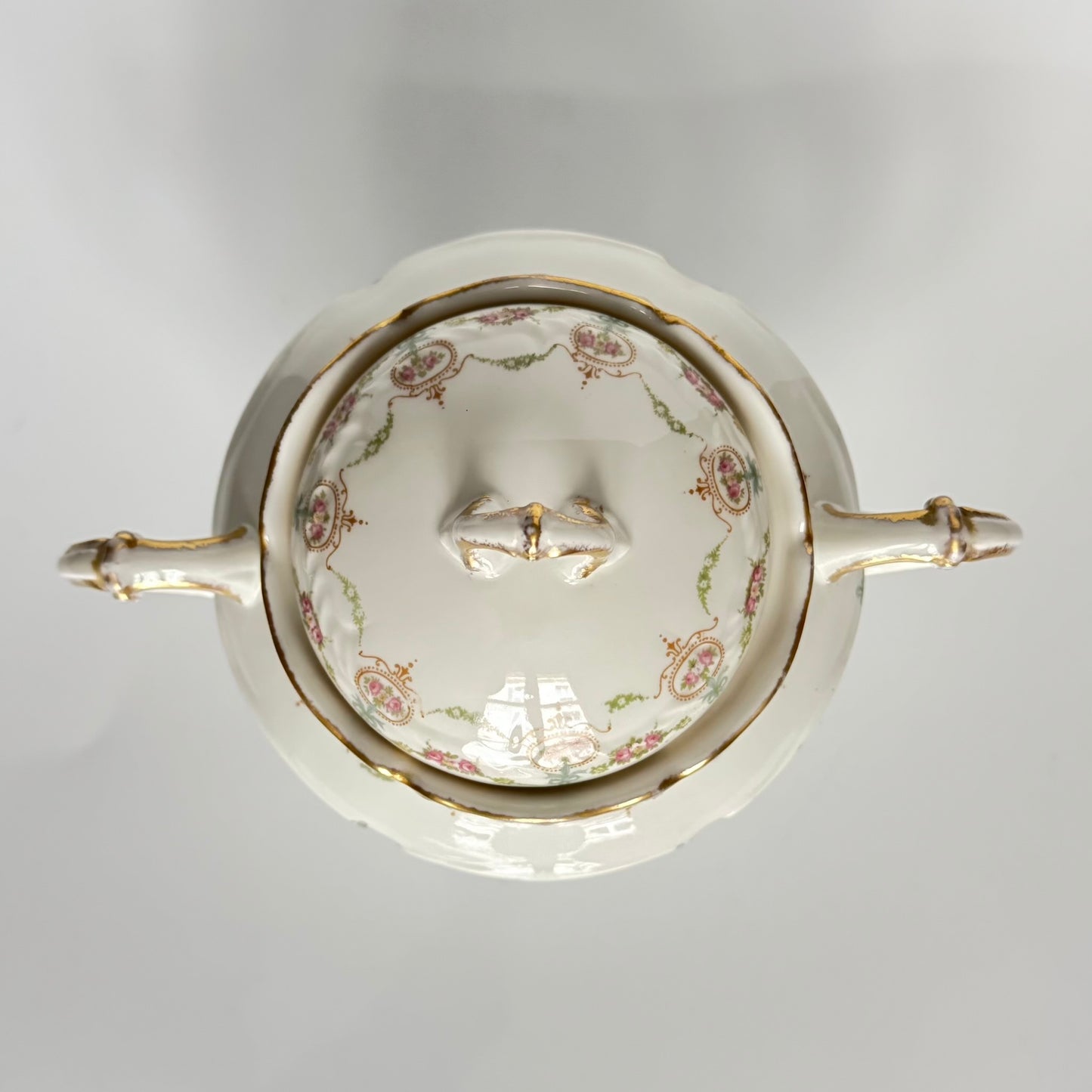 Limoges porcelain tea/coffee pot and sugar pot set with a floral and ribbon design, exuding elegance.