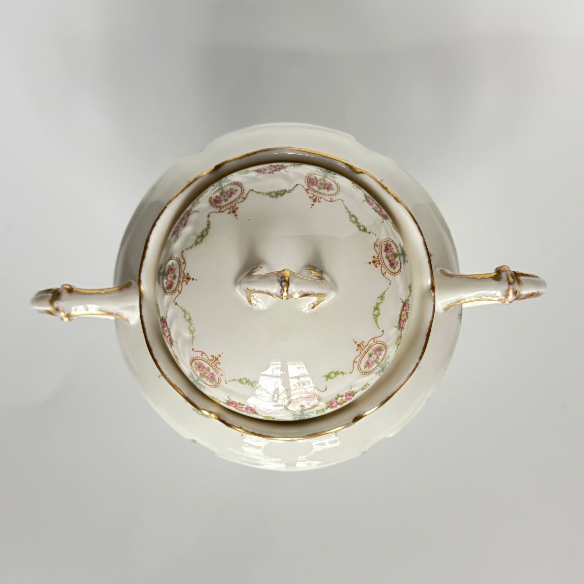 Limoges porcelain tea/coffee pot and sugar pot set with a floral and ribbon design, exuding elegance.